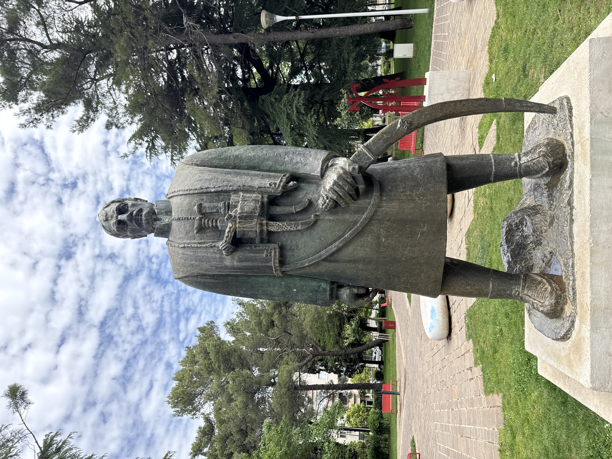 Morning park scenes documented in Podgorica featuring bronze statue