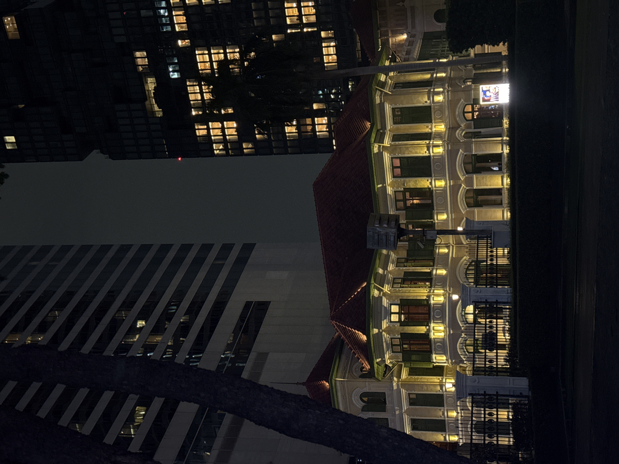 Nighttime Bangkok: colonial facades meet Sathorn skyscrapers