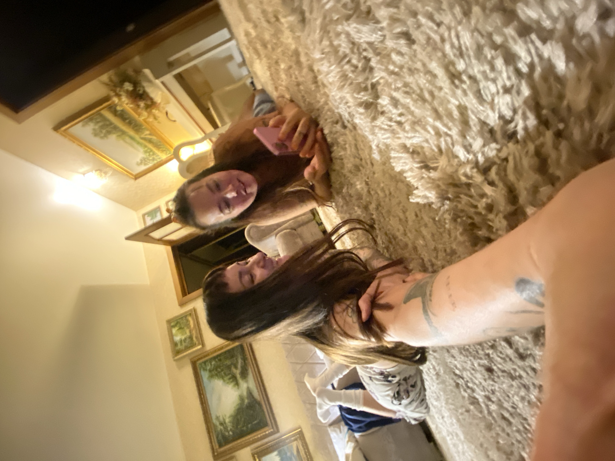 Lazy evening at home with phones, rugs, and a curious cat