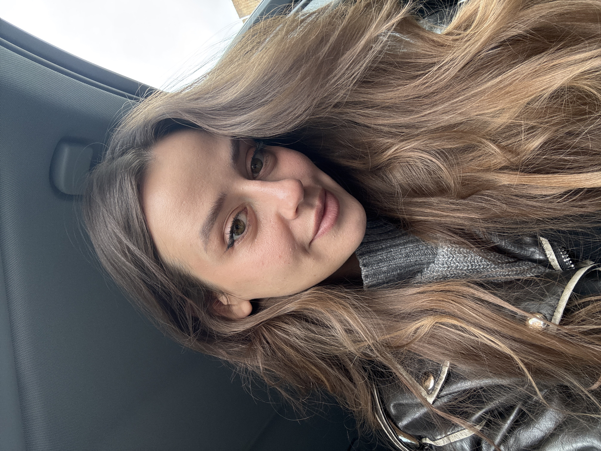 Woman takes selfie in car interior in Krasnoyarsk