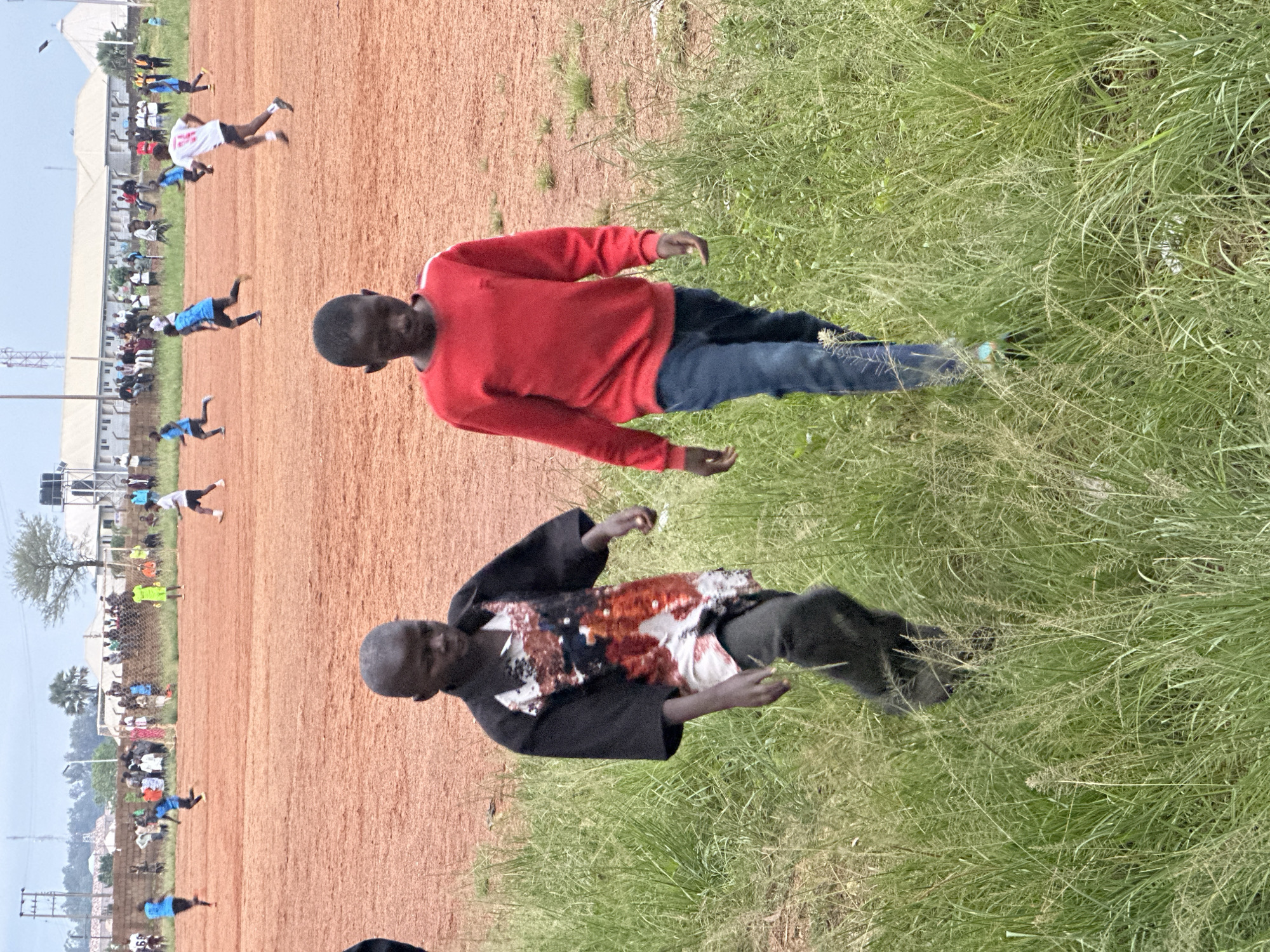 Community soccer match on dirt field in Du, Nigeria