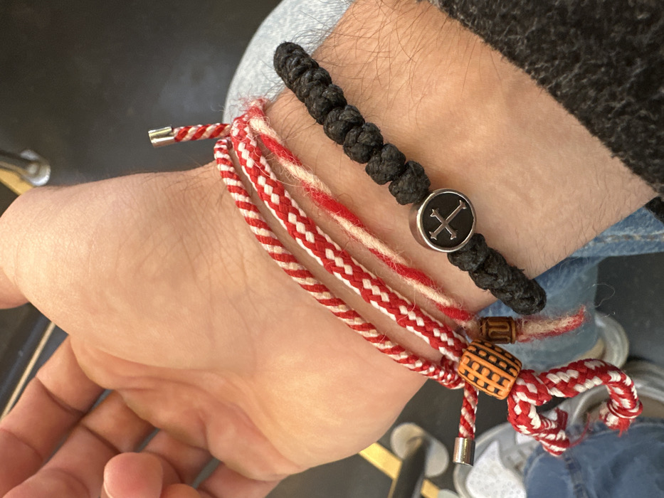 Person wears braided bracelets amid superstition-themed social media content