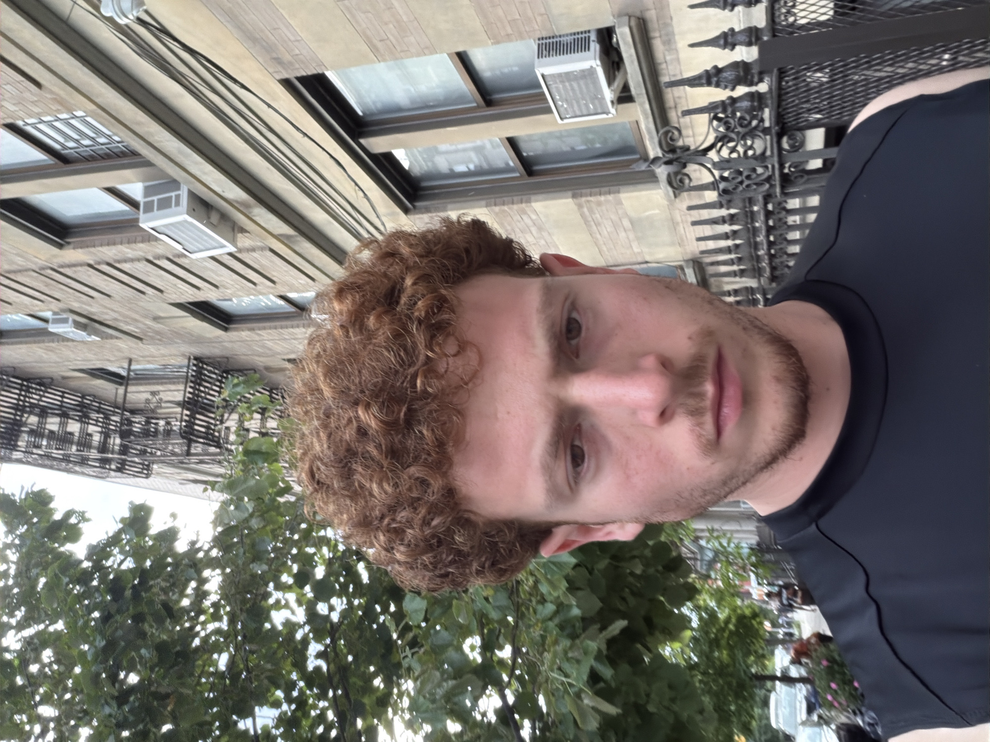 Man spotted near NYC university buildings under overcast evening sky