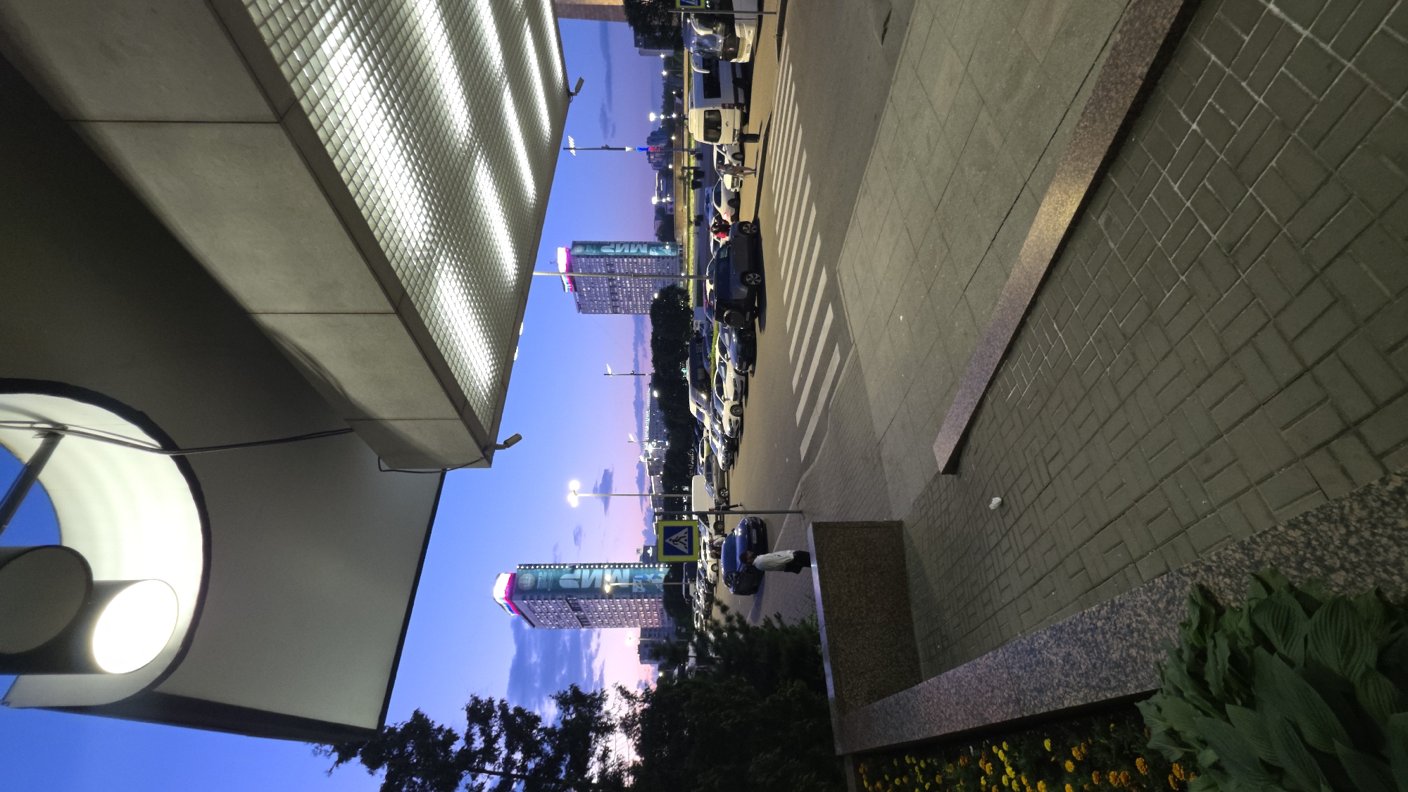 Modern overhang lit up as dusk fades into evening