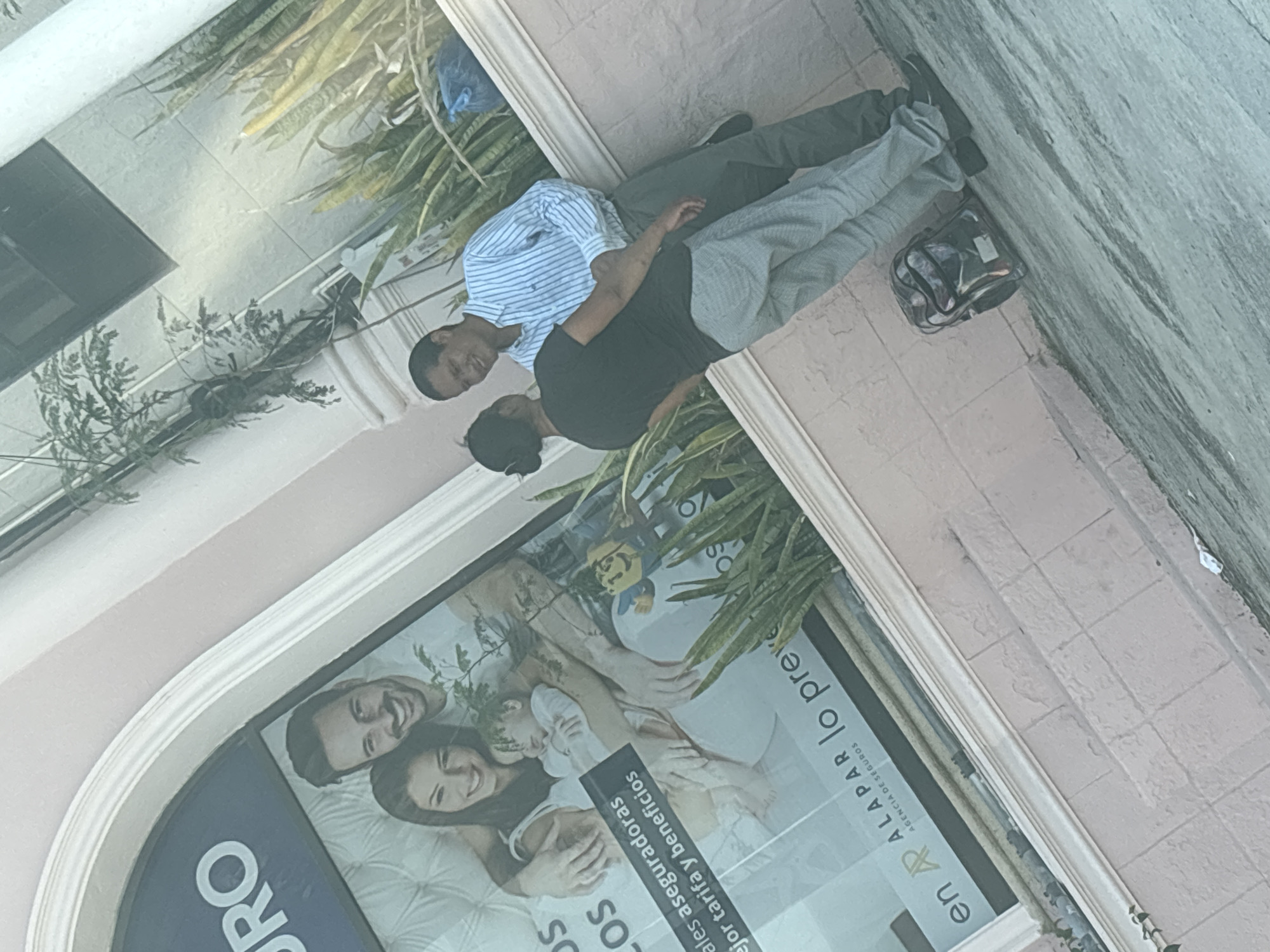 Two men stand outside storefront in Tampico, Mexico
