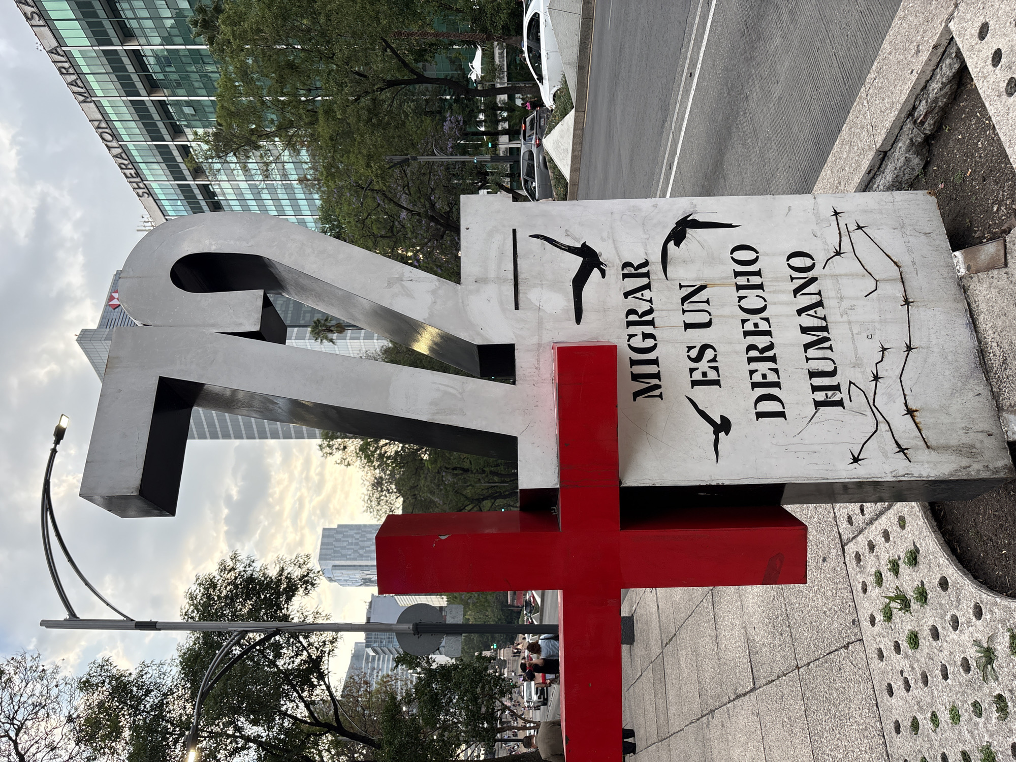 Migrant memorial monument with metallic "72" sculpture documented in Mexico City