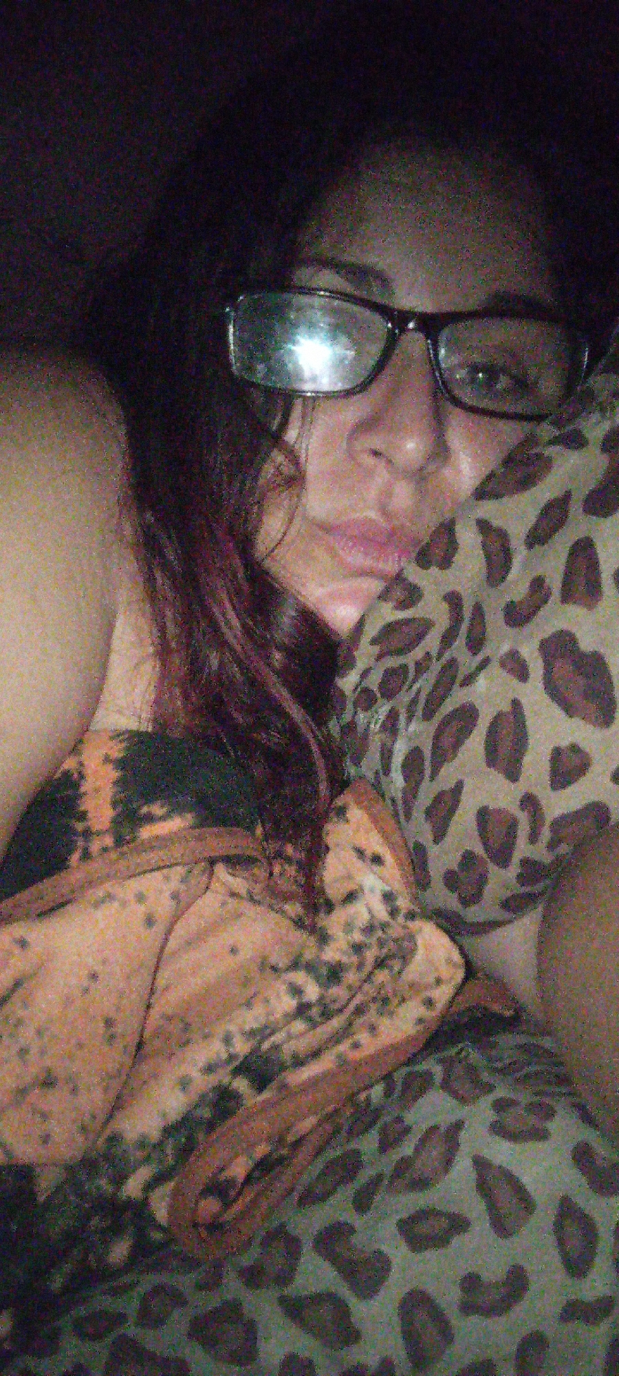 Woman rests on spotted pillow wearing tie-dye clothing