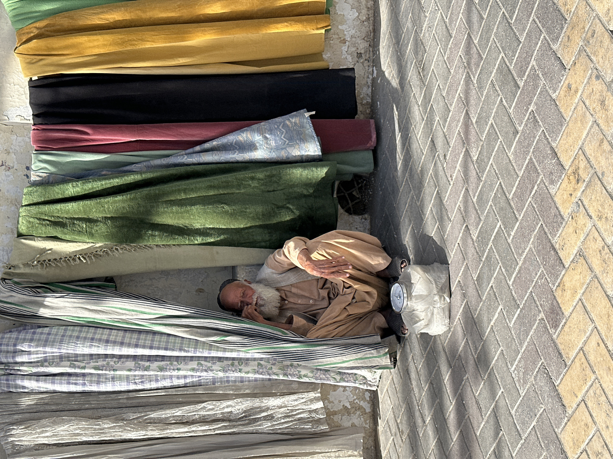 Midday street life along a busy Quetta sidewalk