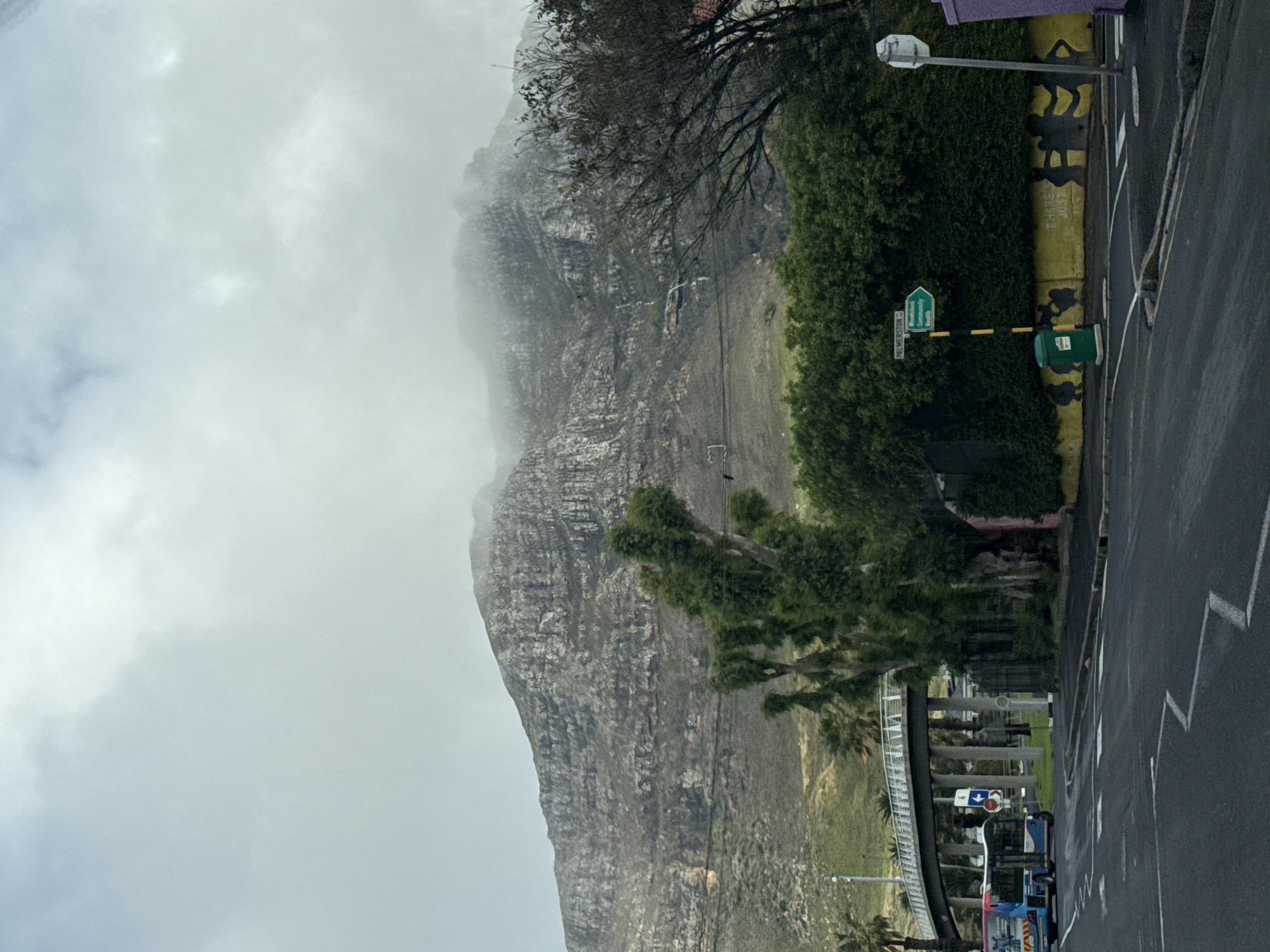 Misty Table Mountain witnessed during rainy Cape Town street journey