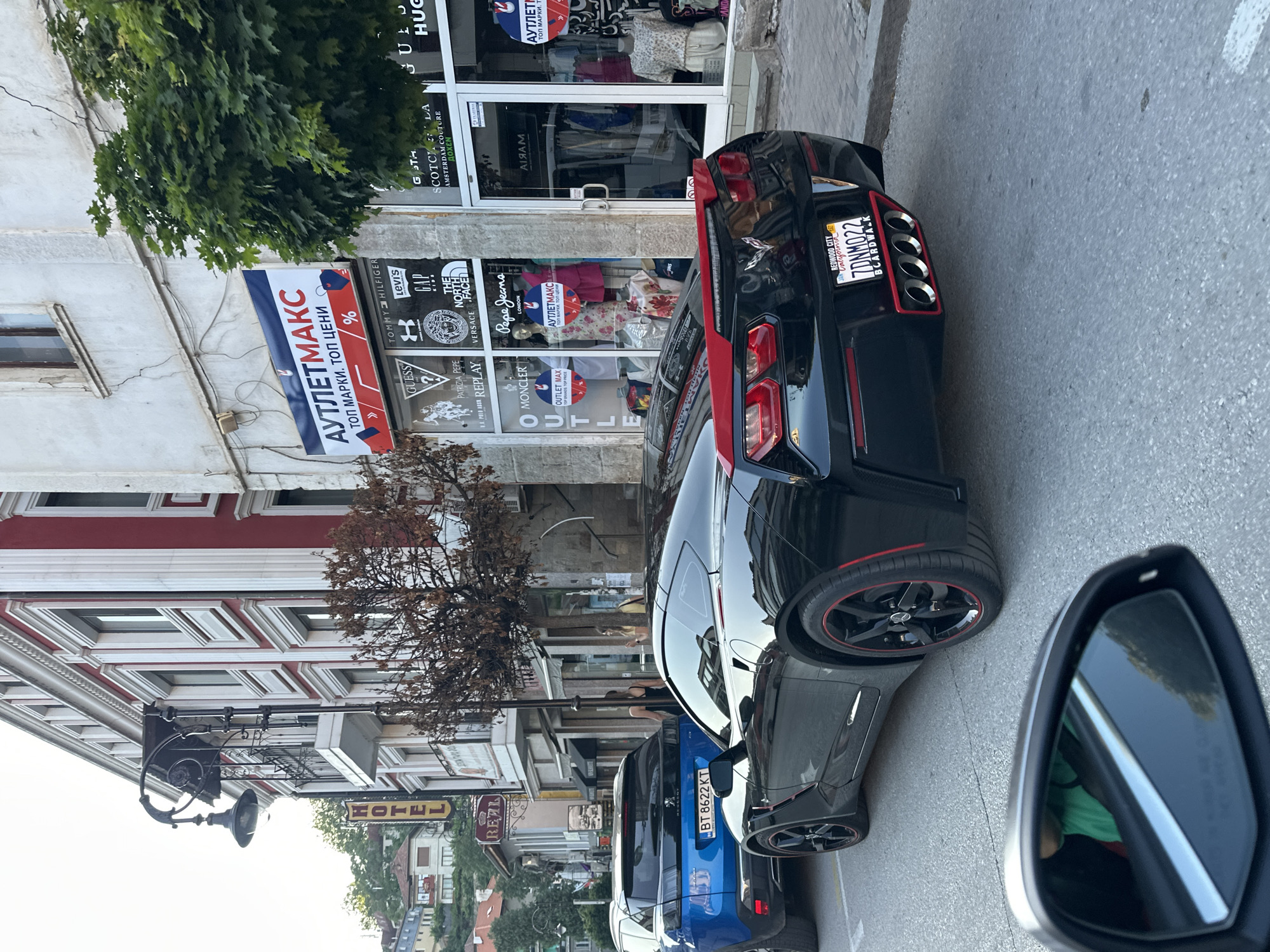 Street juggler performs amid luxury cars in Veliko Tarnovo