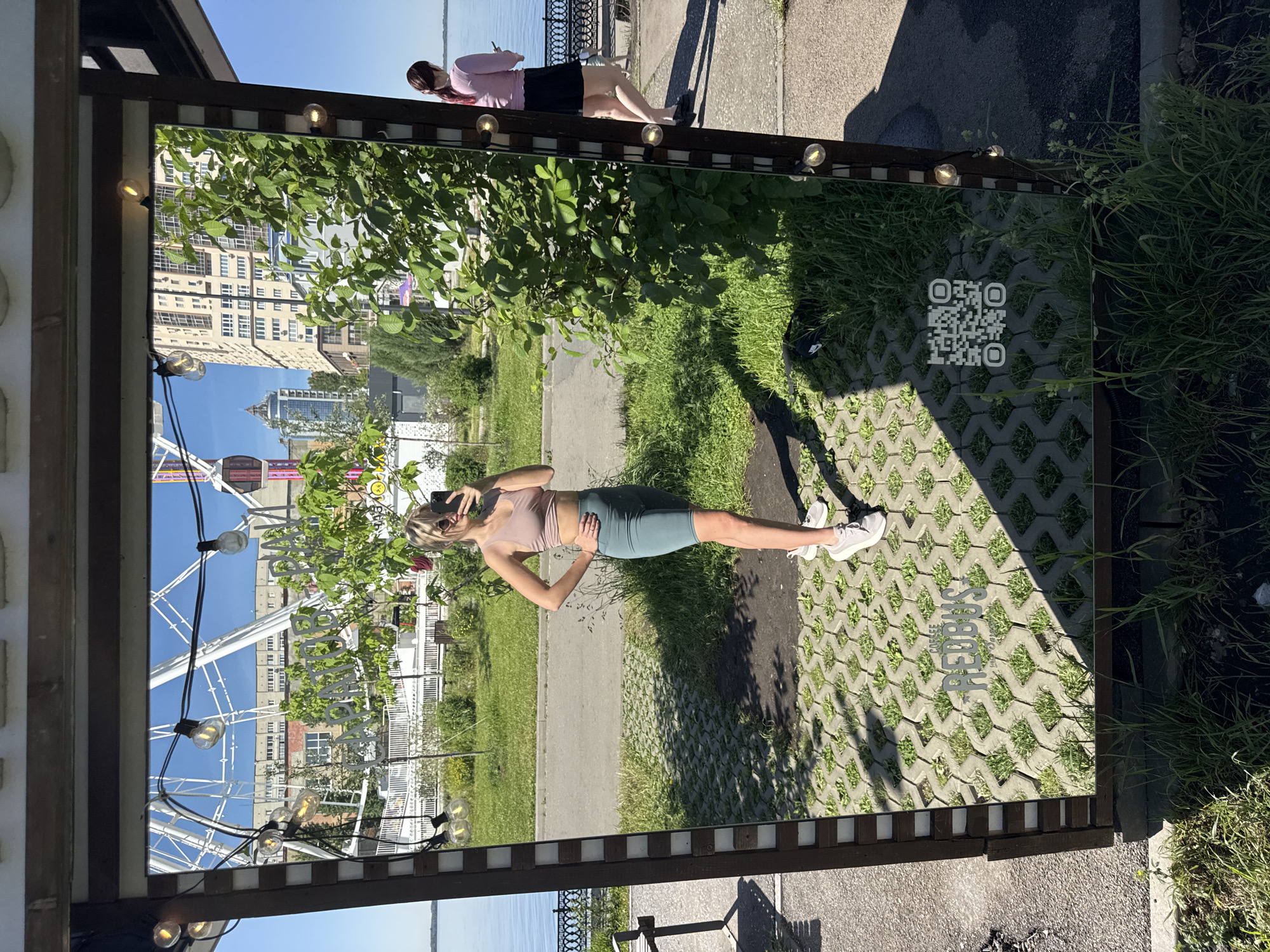 Woman takes morning selfies at mirrored Saratov embankment installation