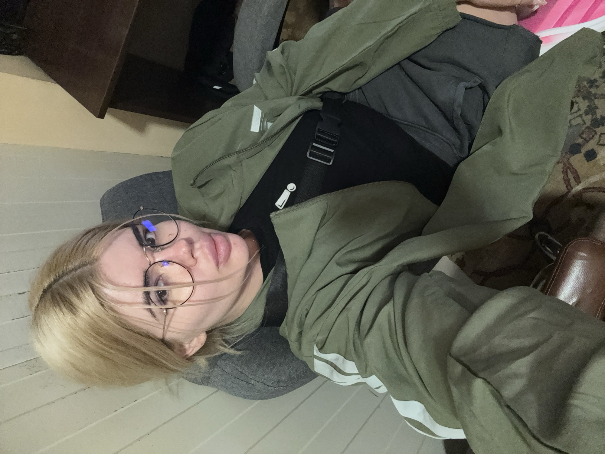 Sitting indoors in Rakovski, casual pose toward camera.