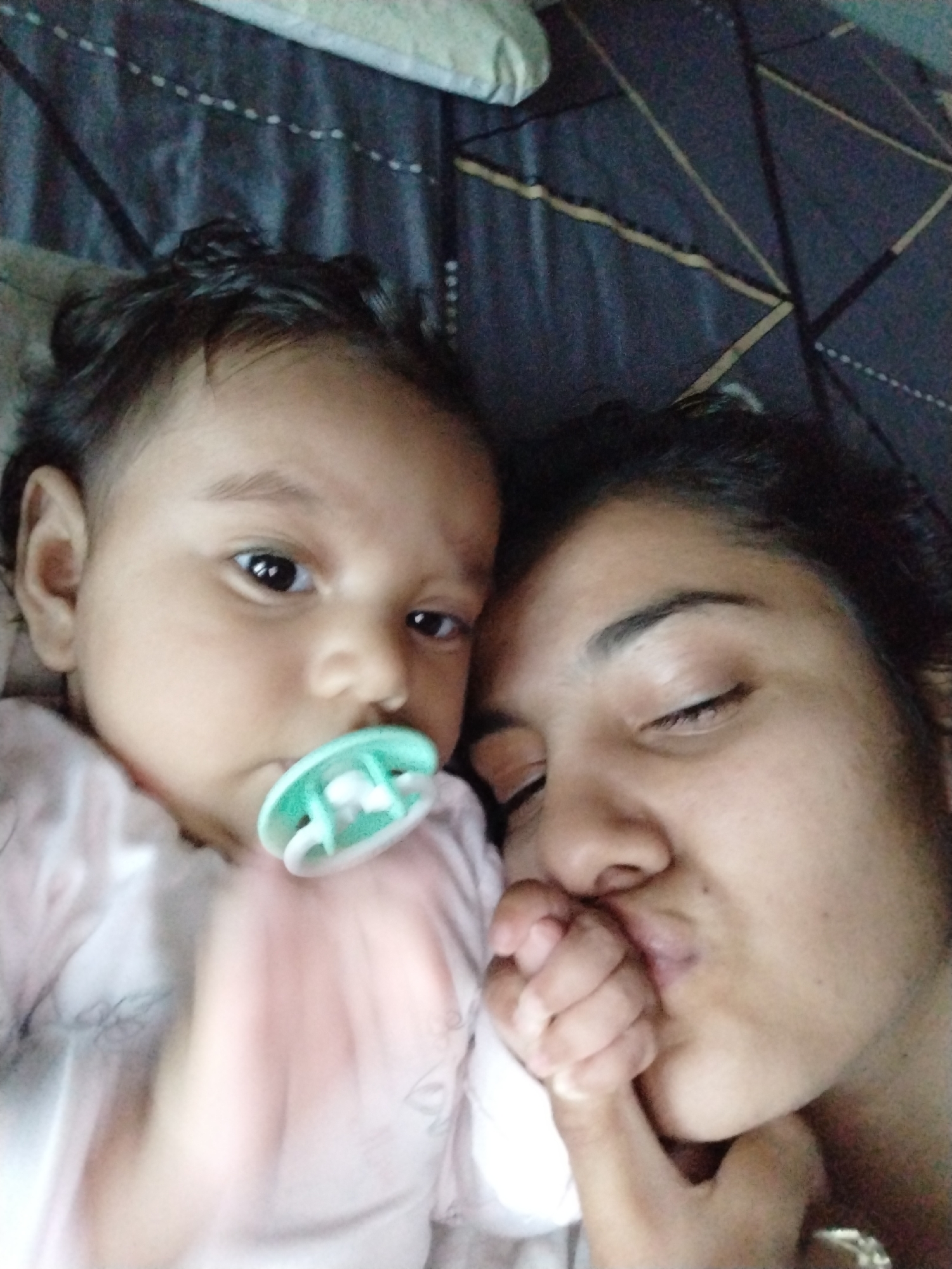 Mother and baby share quiet bedtime moments in selfies