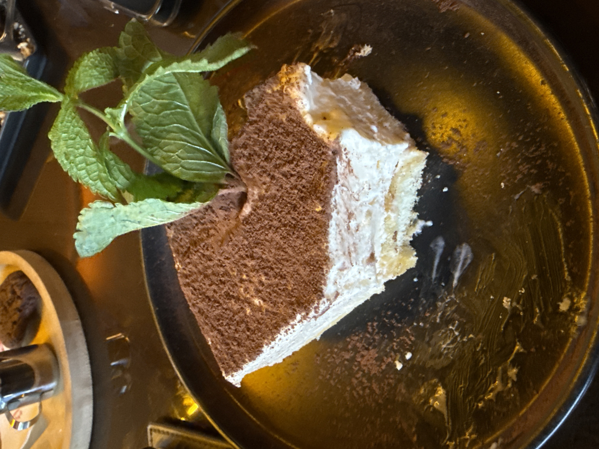 Tiramisu slice with mint garnish, plated in Yerevan