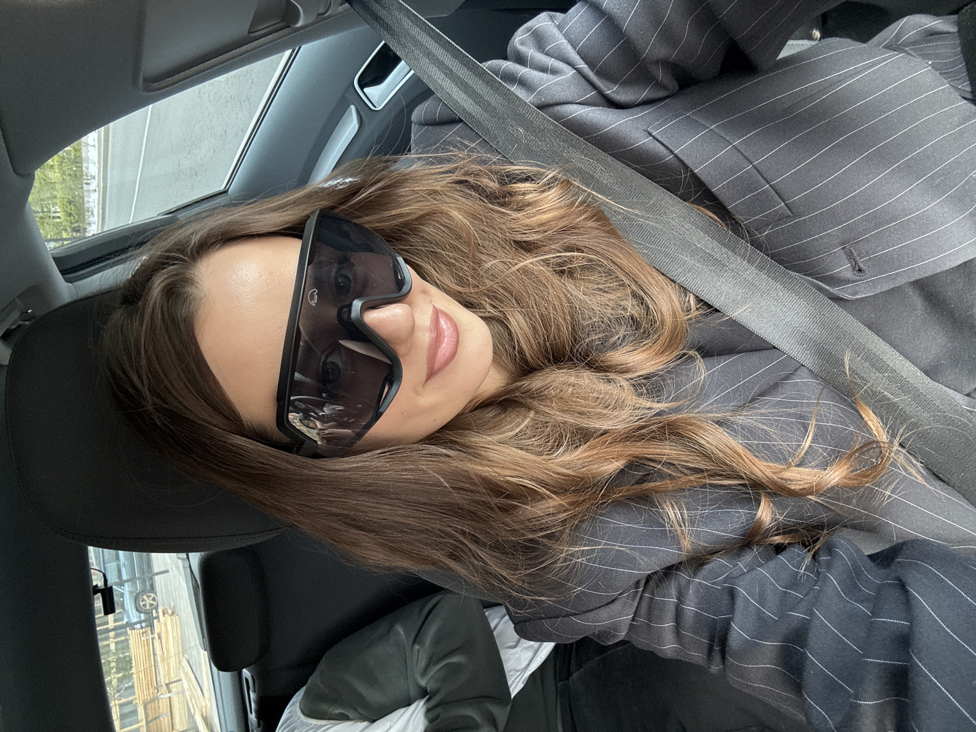 Woman in pinstripe suit observed in car in Krasnoyarsk