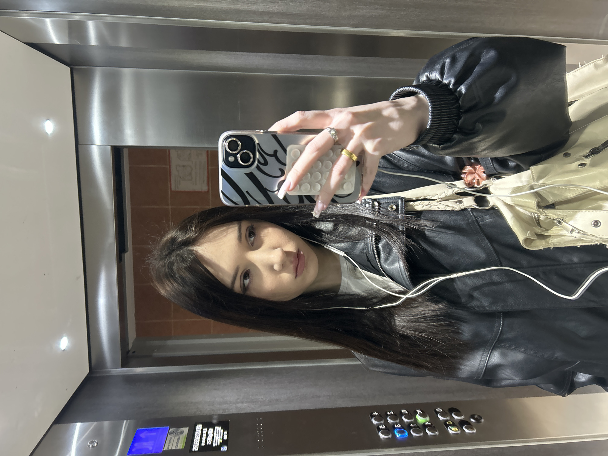 Woman takes selfie in elevator in Cachan, France