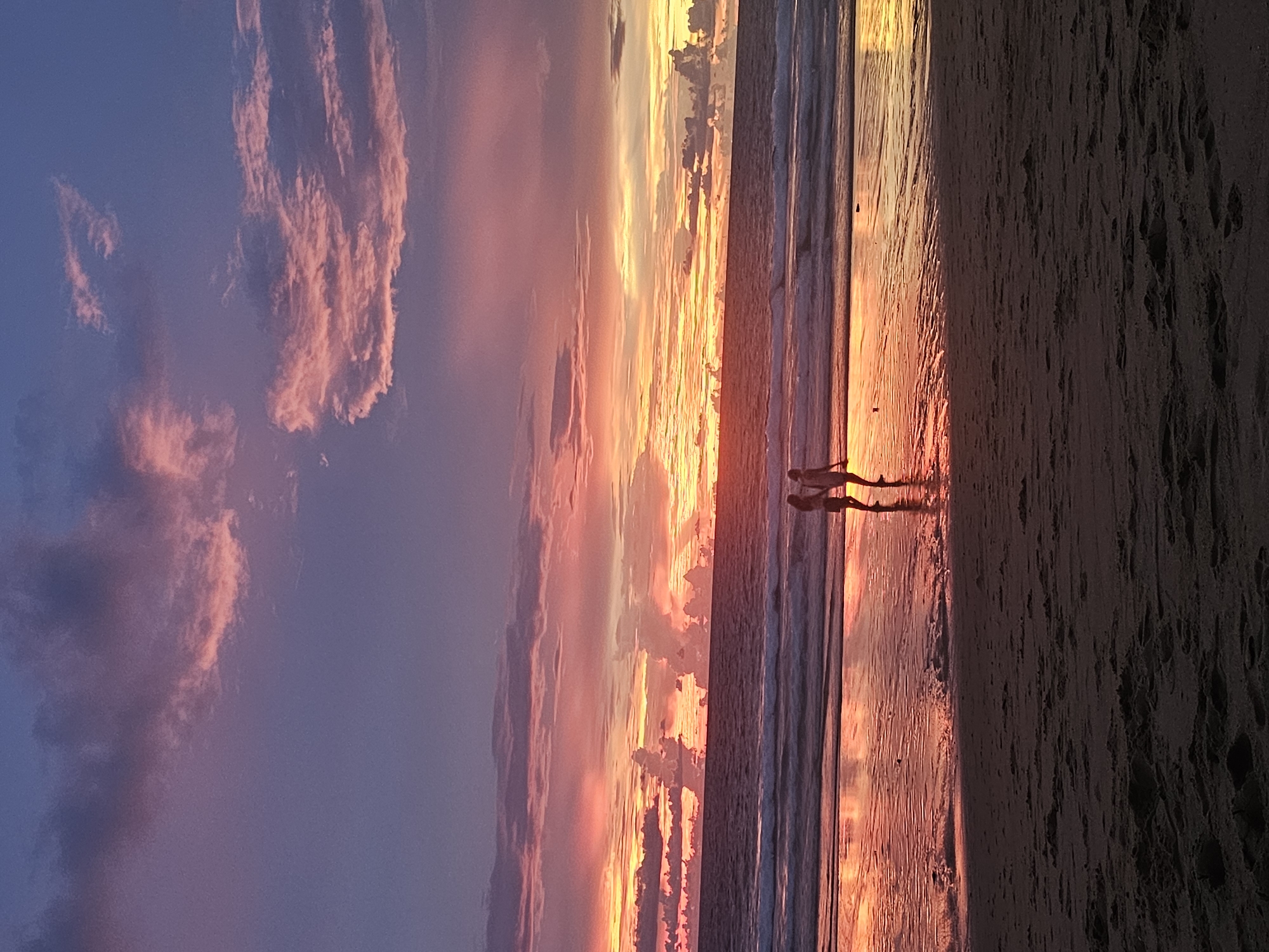Beach sunset in Sakhu, Thailand, with people unwinding at dusk