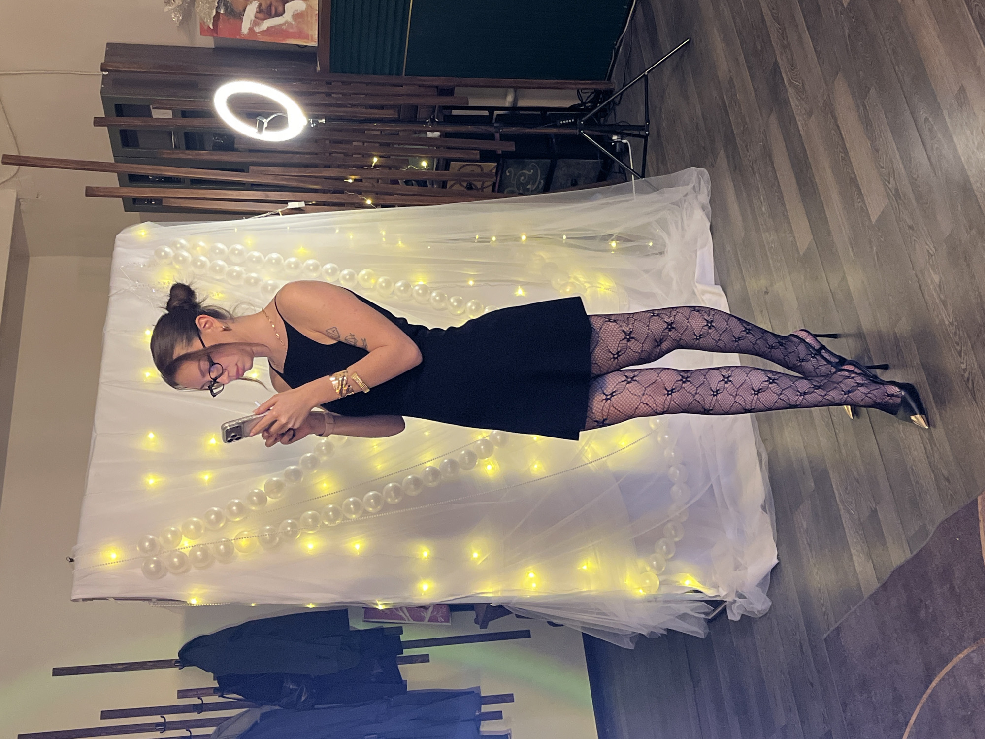 Woman poses with phone against decorative backdrop in Saint Petersburg