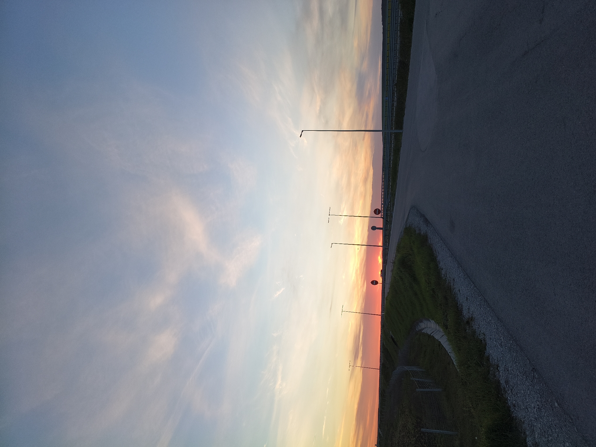 Colorful sunset captured over rural highway in Gradishte, Bulgaria