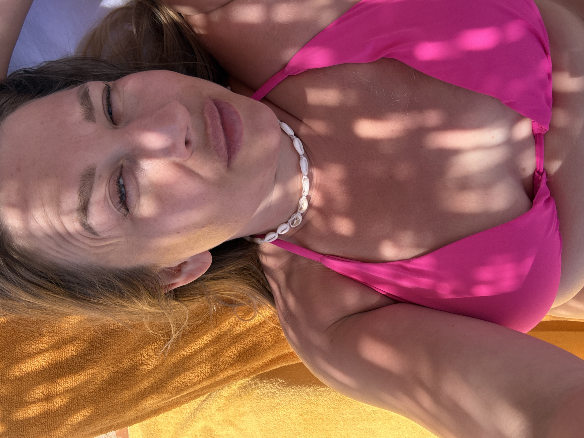 Woman sunbathing in pink bikini observed in Sharm El Sheikh