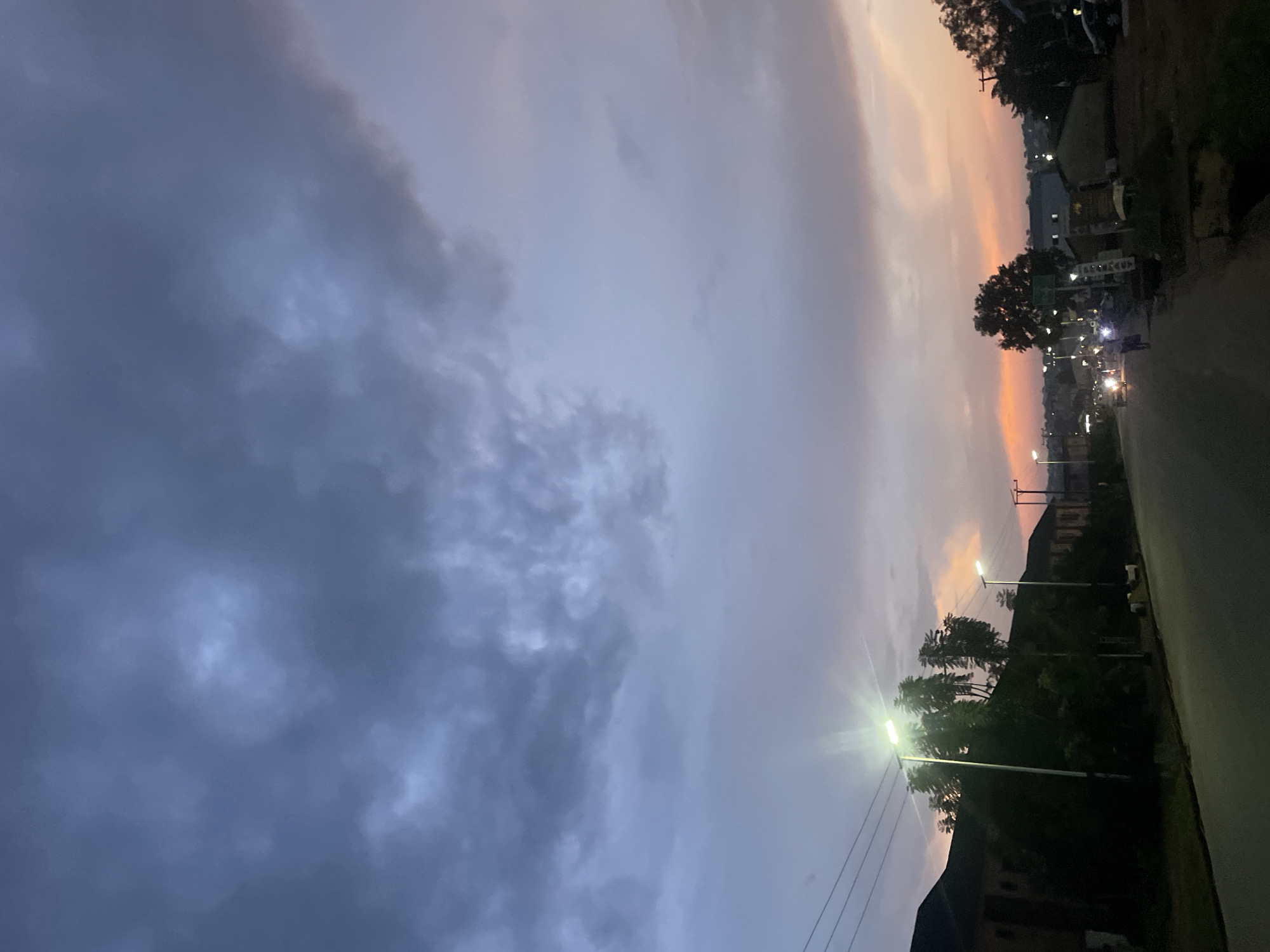 Evening street life and sunset skies in Jos, Nigeria