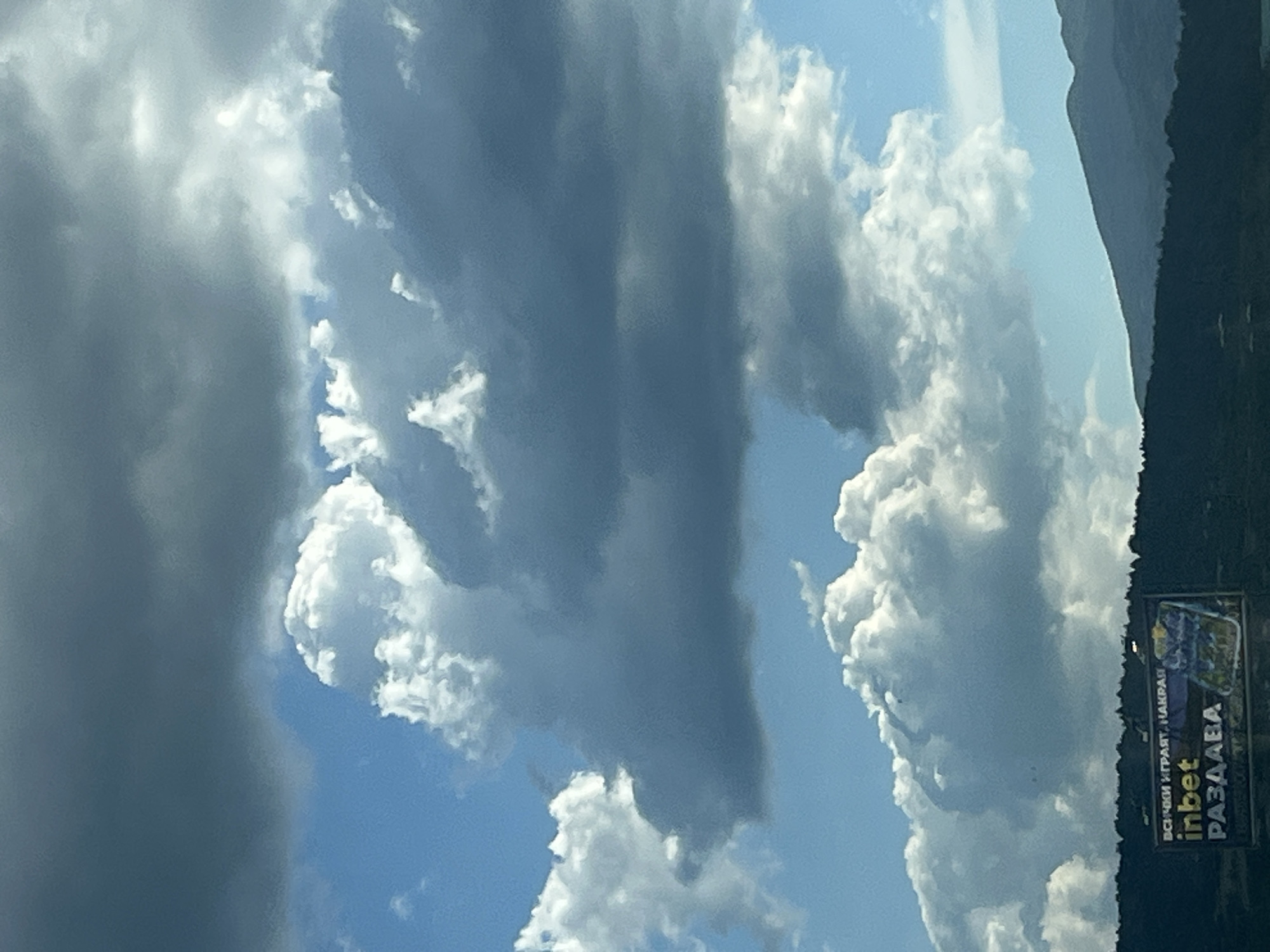 Highway drive through mountains under dramatic summer skies