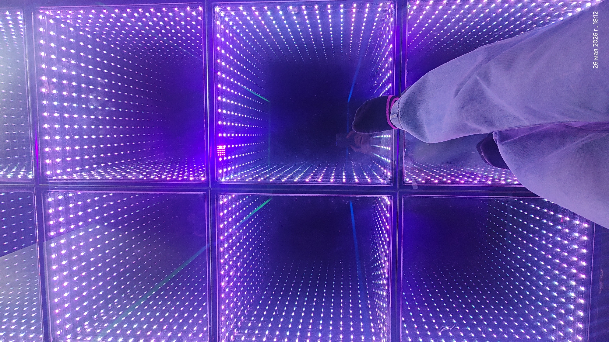 Person experiences optical illusion tunnel floor installation in Almaty
