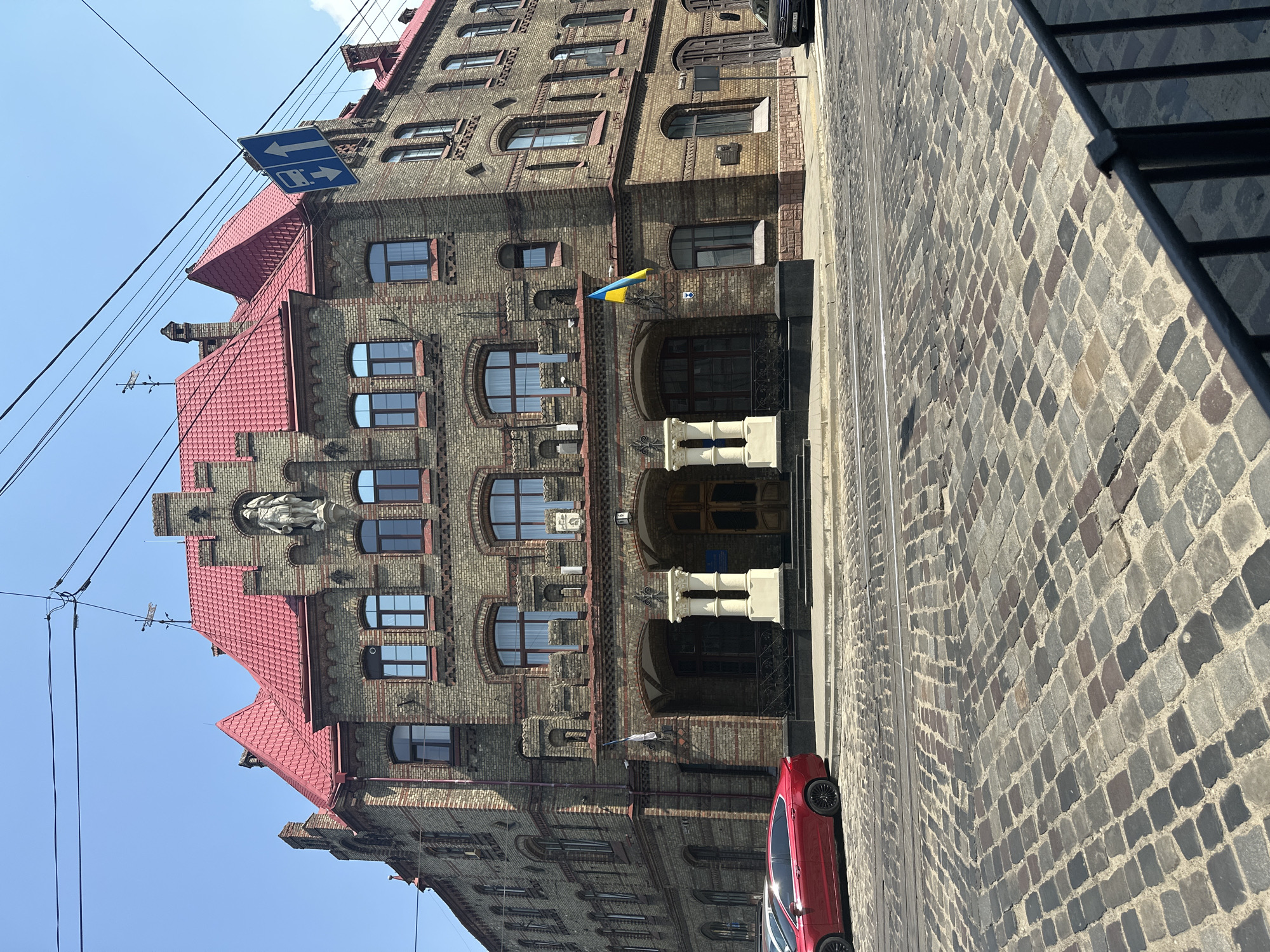 Historic brick building with mansard roof under clear skies