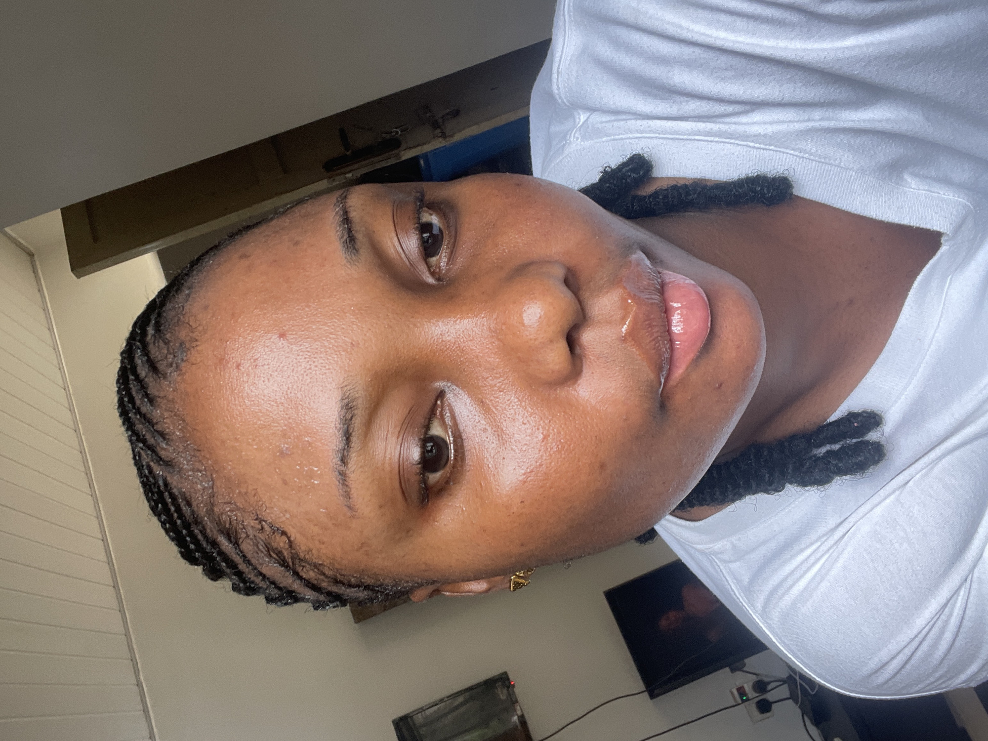 Woman takes morning selfies applying makeup in Abuja home