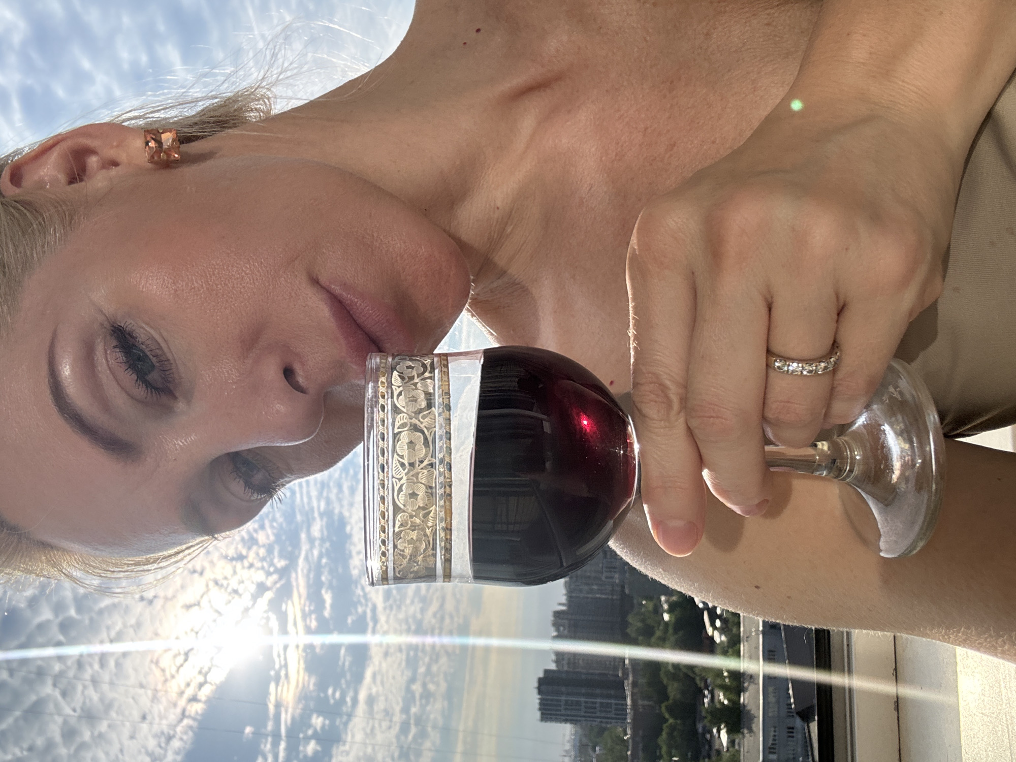 Woman enjoys wine and fruit on Russian balcony afternoon