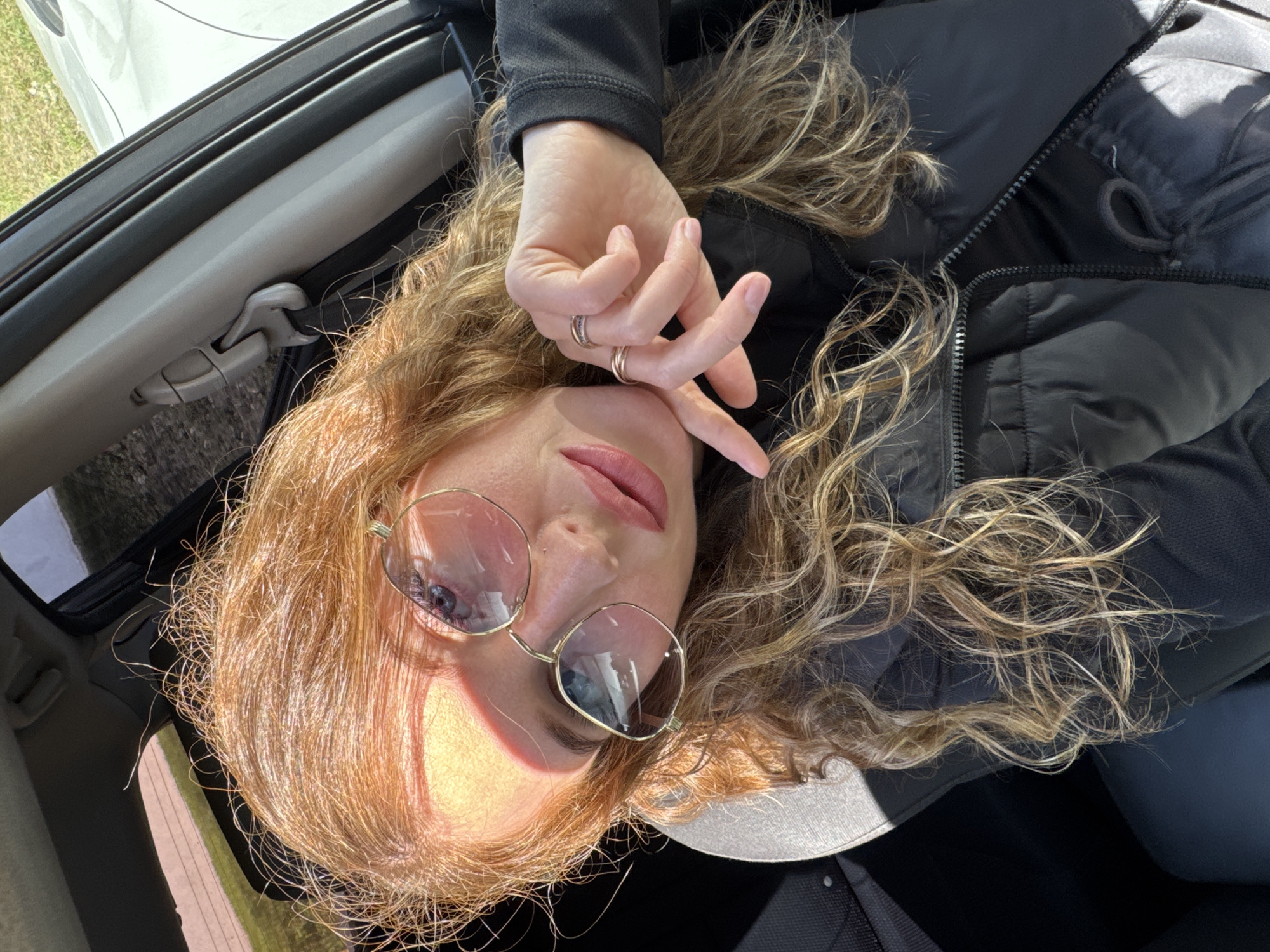 Woman rests in passenger seat in Chaikovsky, Russia