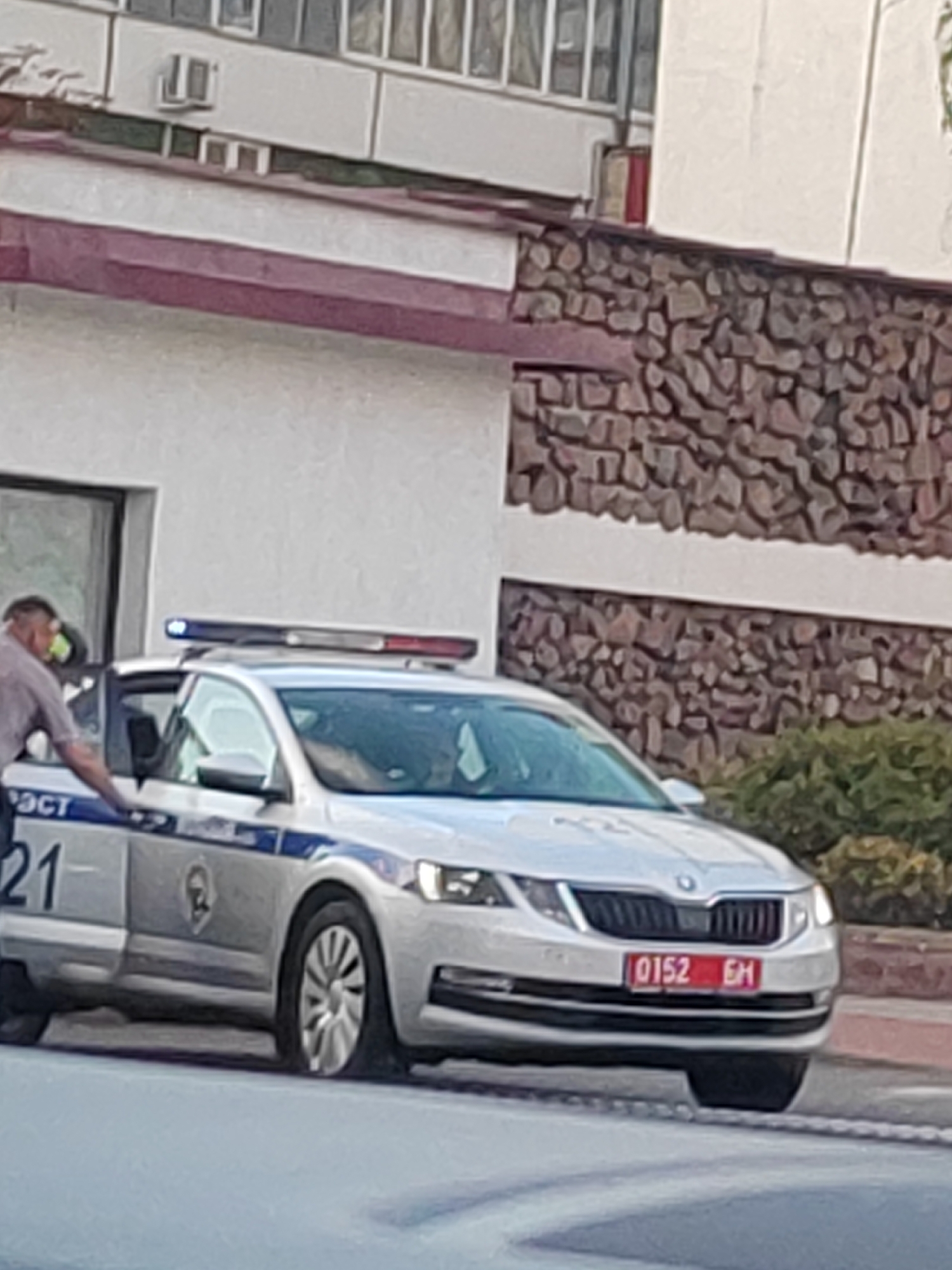 Police car and striped civic building in central Brest