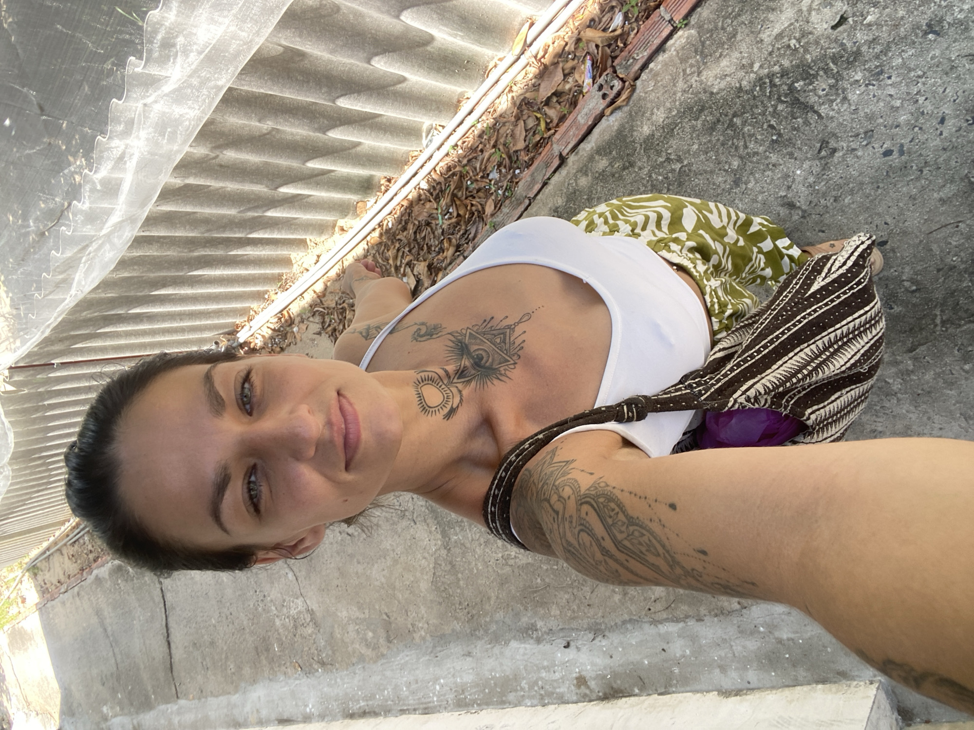 Woman takes selfies outside house in Mũi Né, Vietnam