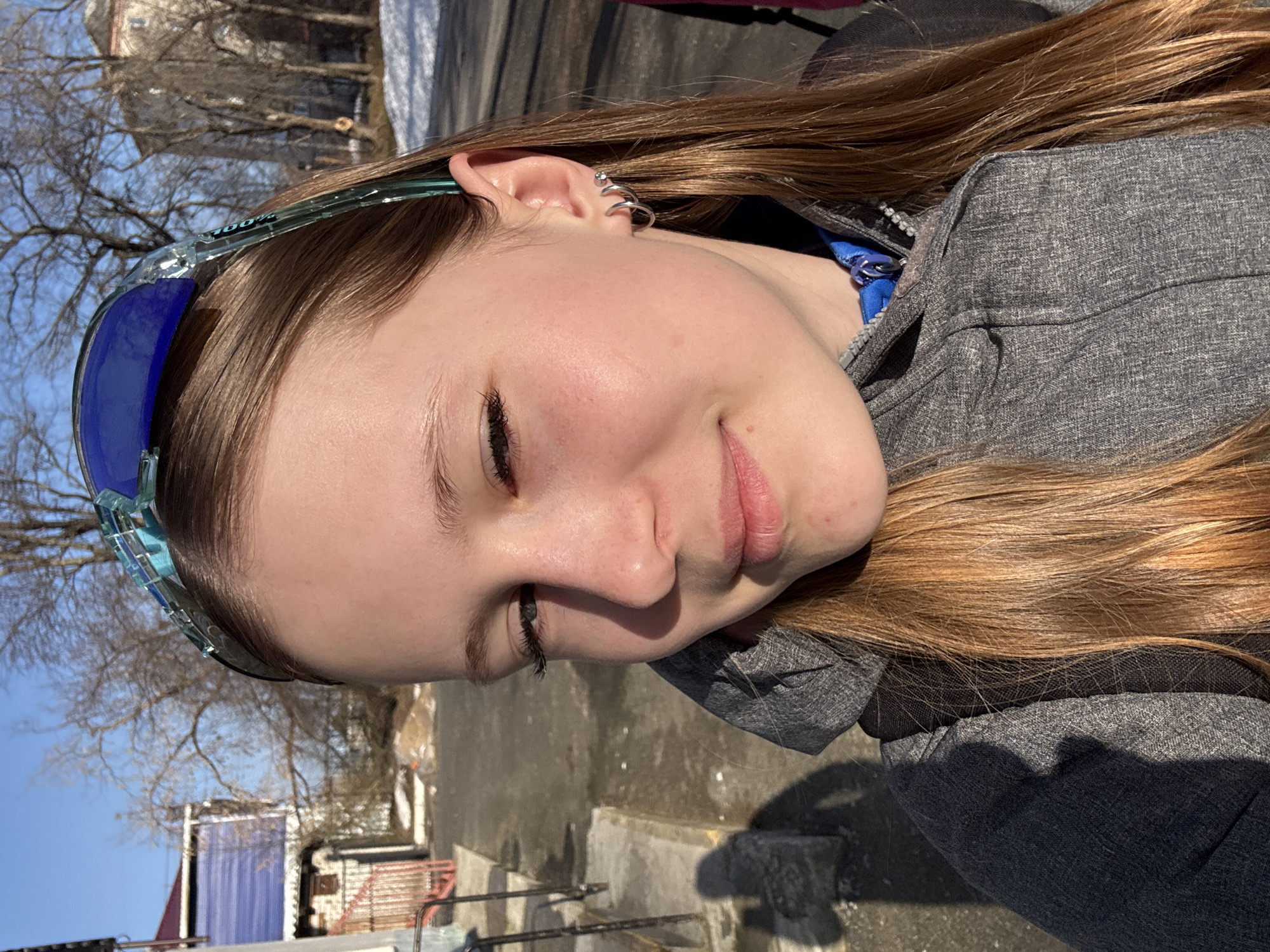 Young woman photographed in Berezniki wearing sunglasses, silver earrings