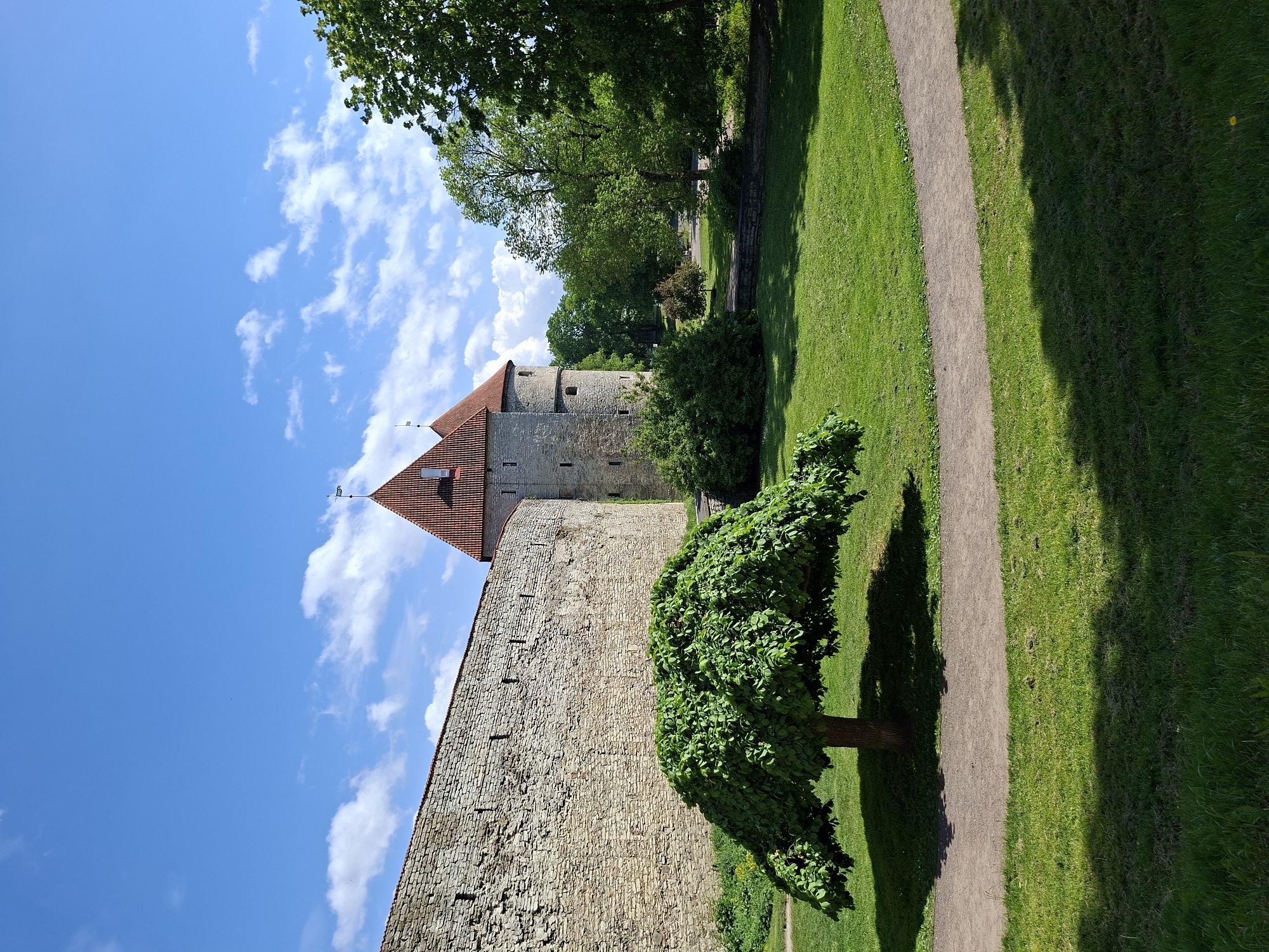 Tourist documents sunny walking tour through Tallinn's historic Old Town