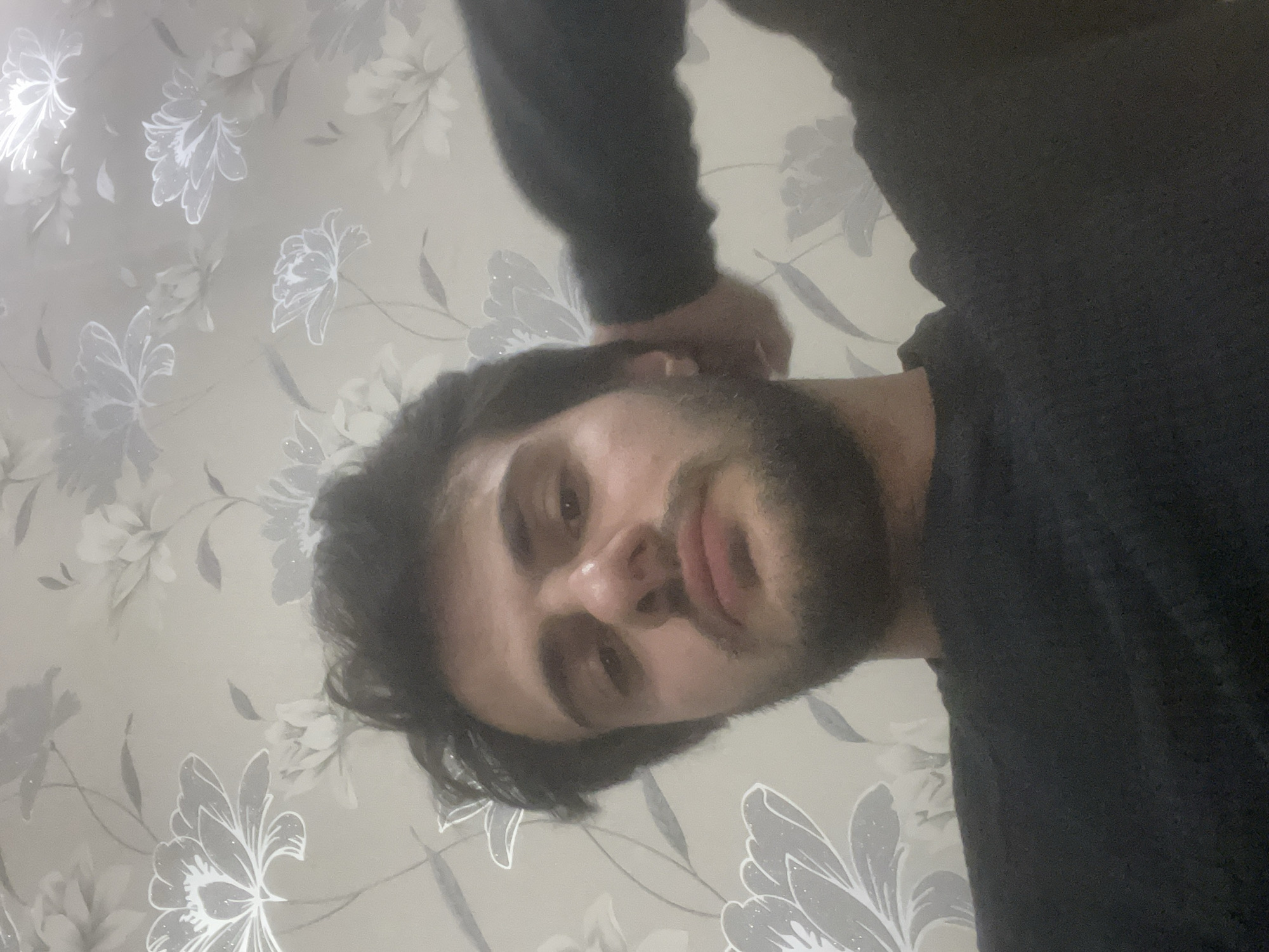 Man photographed multiple times in Tbilisi indoor setting