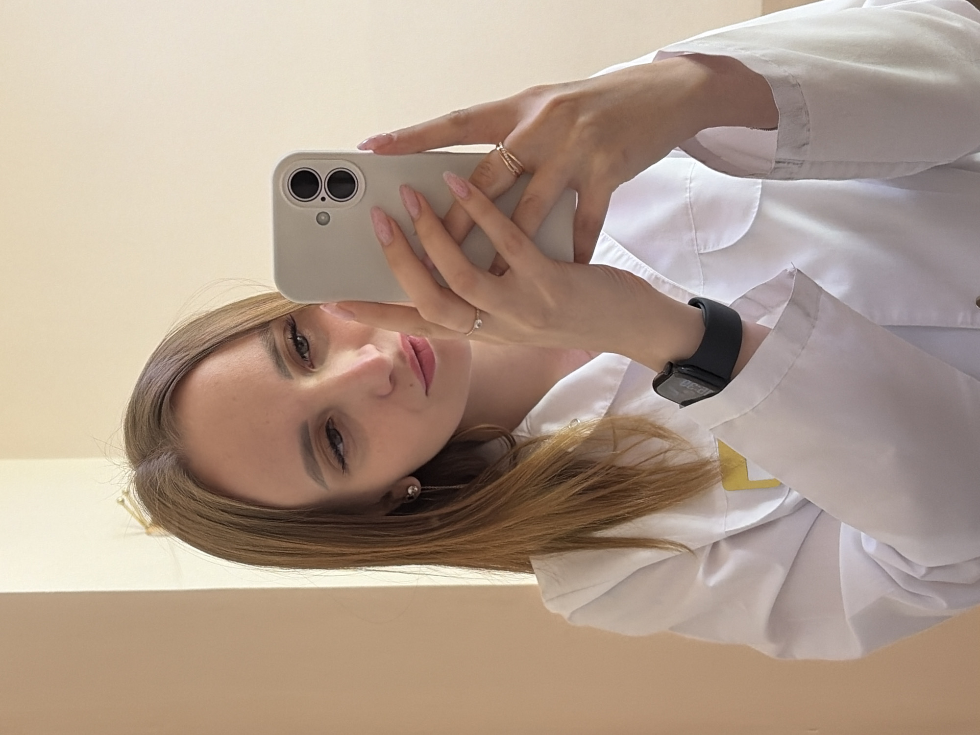 Woman in lab coat takes selfie in Chaikovsky, Russia