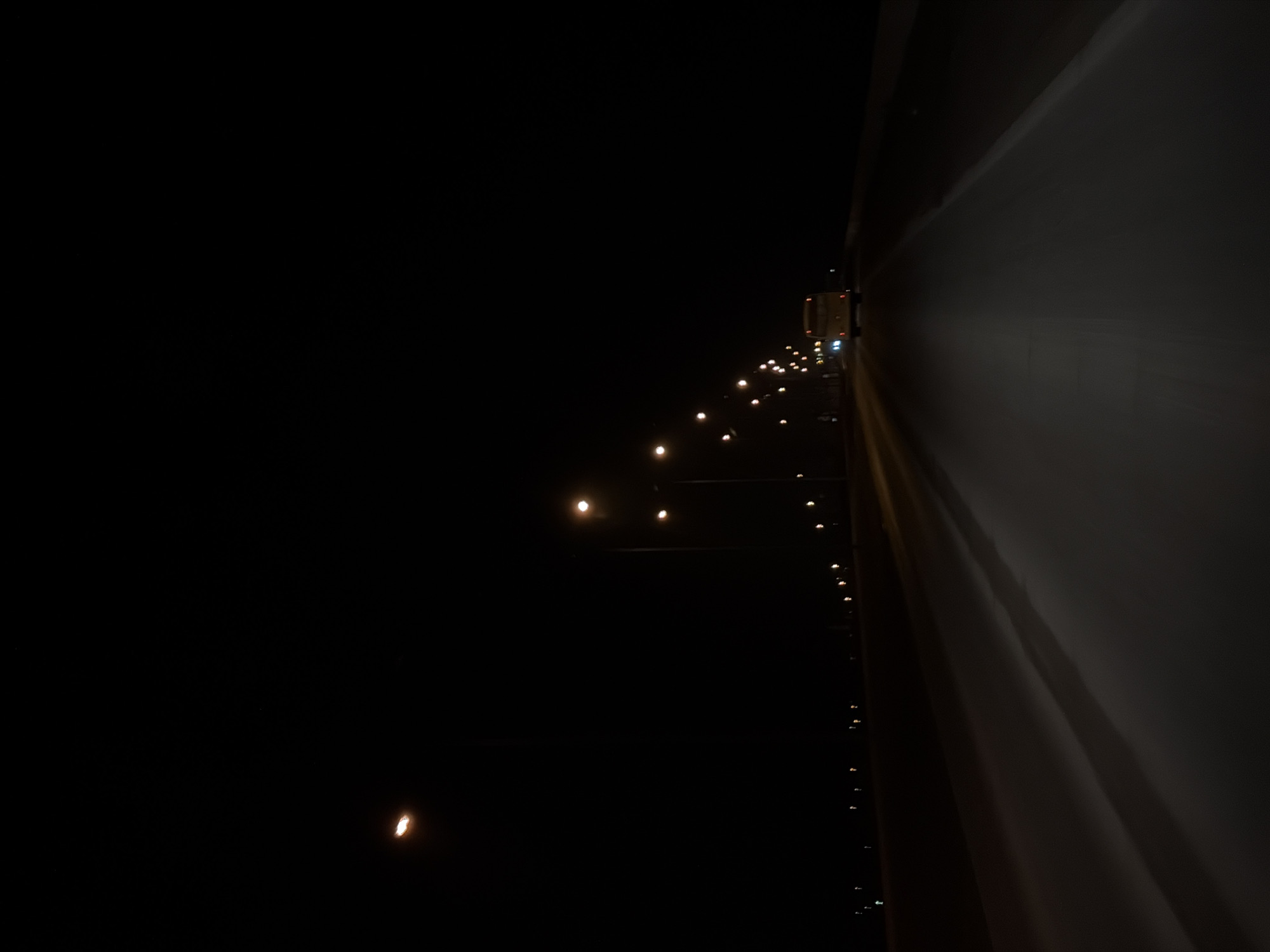 Vehicle travels illuminated highway in Chaikovsky, Russia