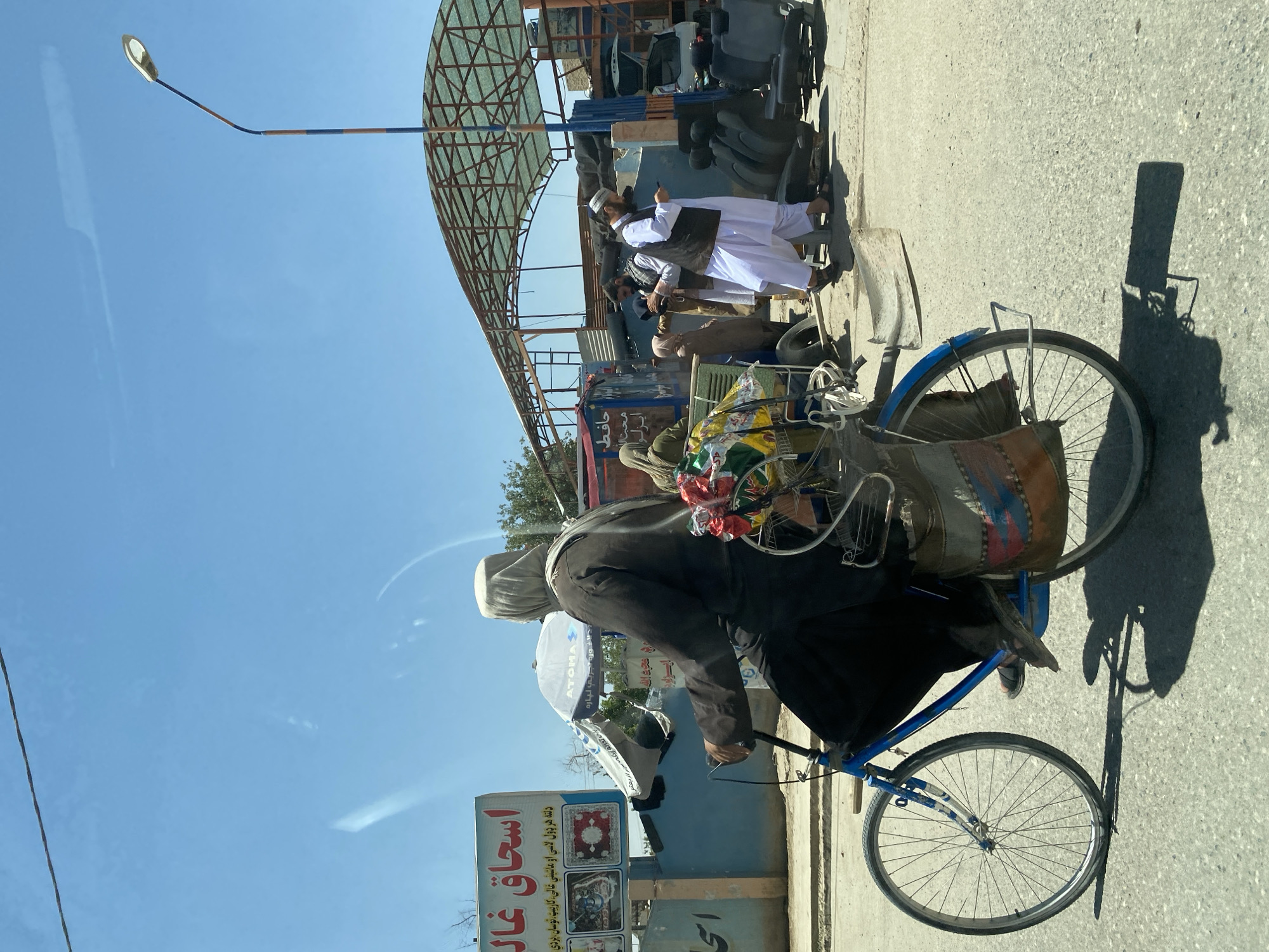 Cycling through a sunny Kandahar street