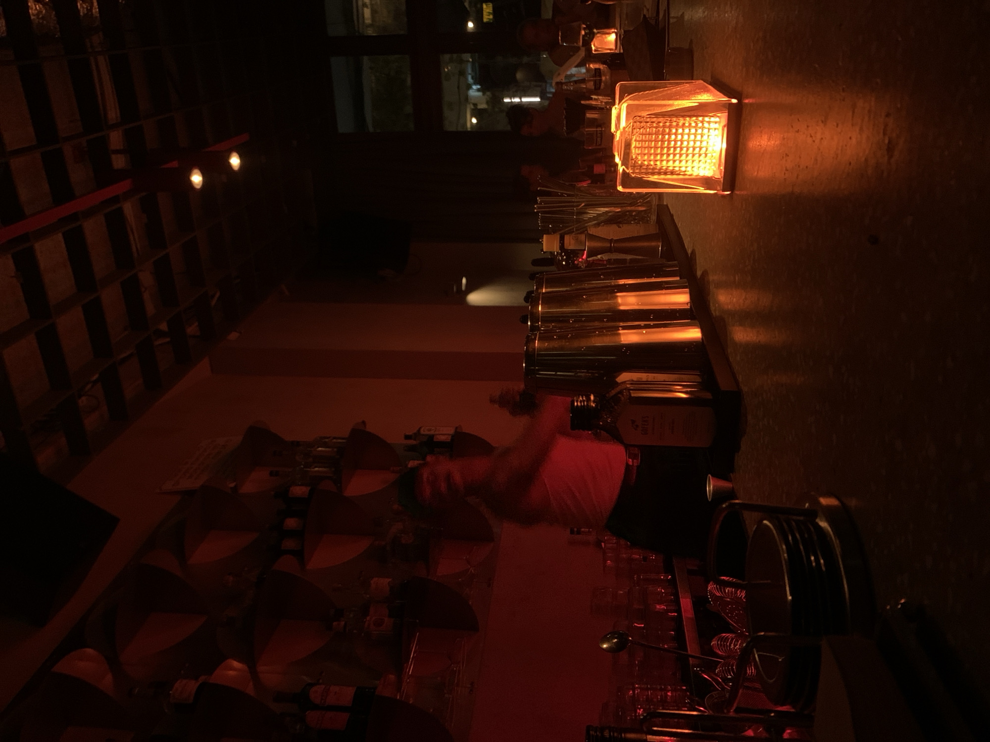 Red-lit bar interior glowing with caged lanterns, Tel Aviv