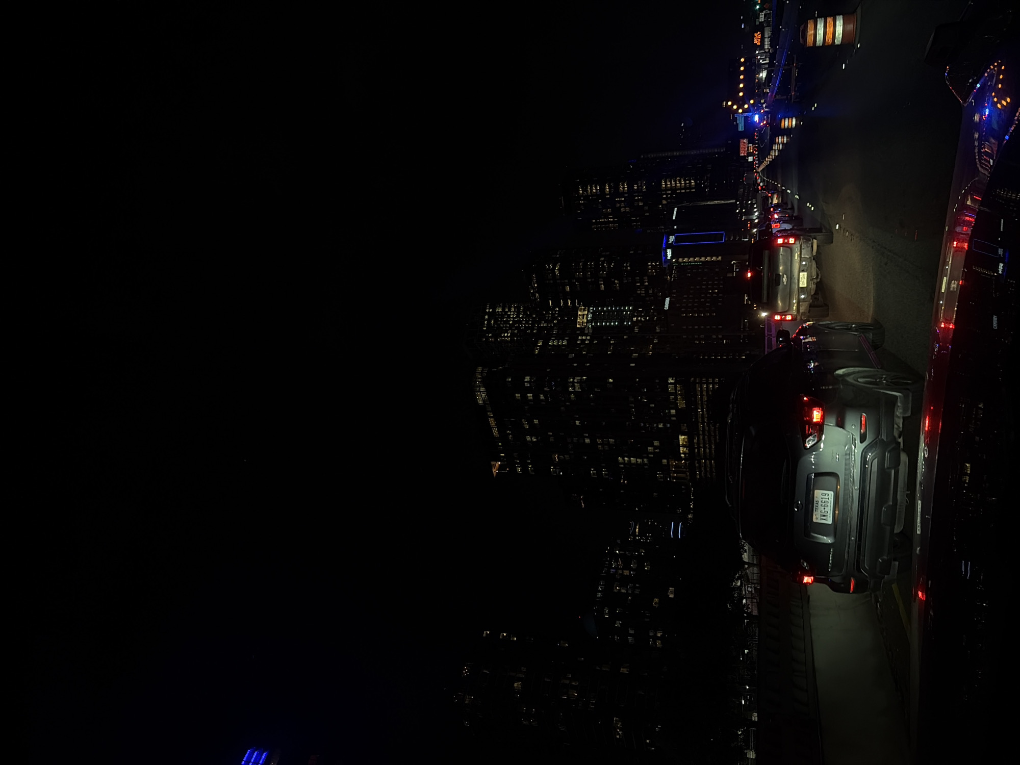 Gray SUV parked on Austin street at night