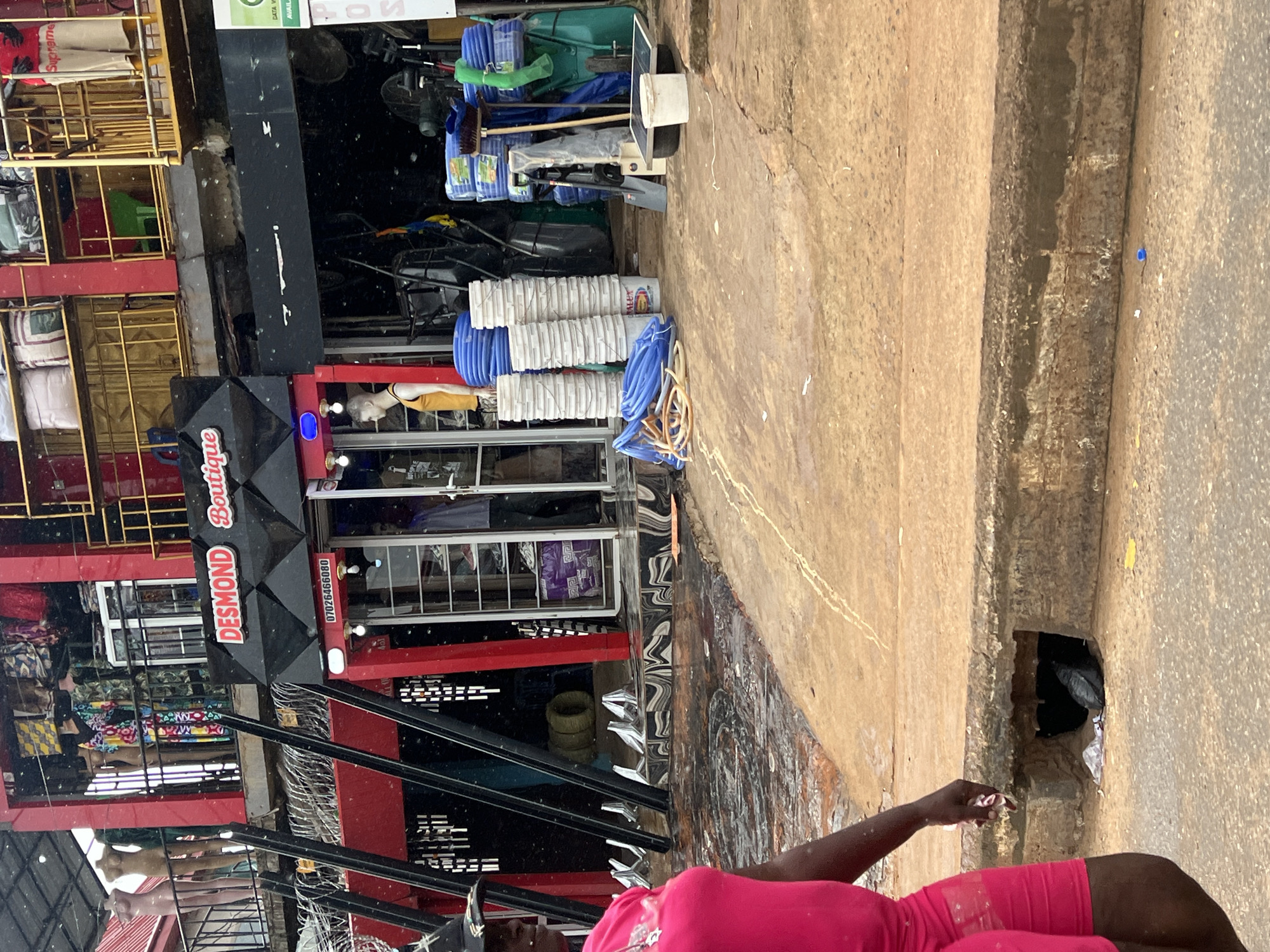 Busy street day outside Desmond Boutique in Okpanam, Nigeria