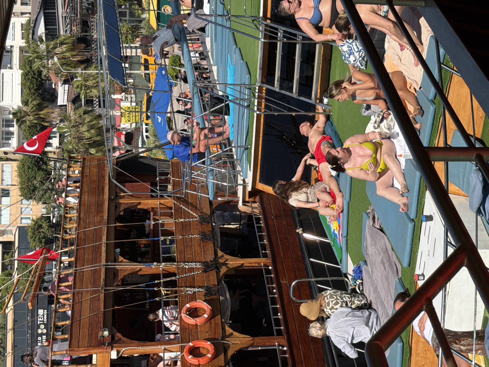 Tourist documents morning boat tour of Alanya coastline landmarks
