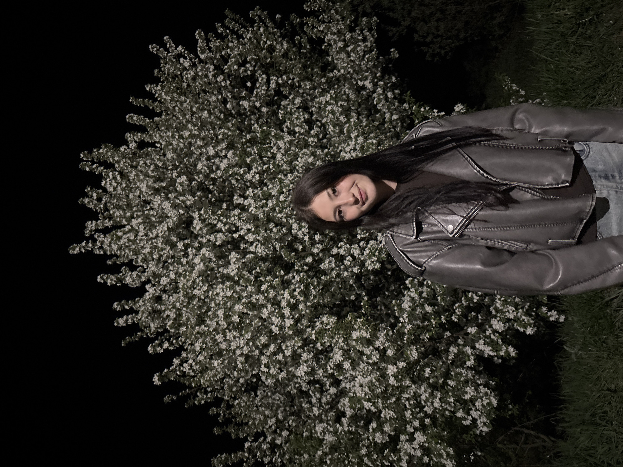 Woman observed near blossoming tree in Фоки park at night
