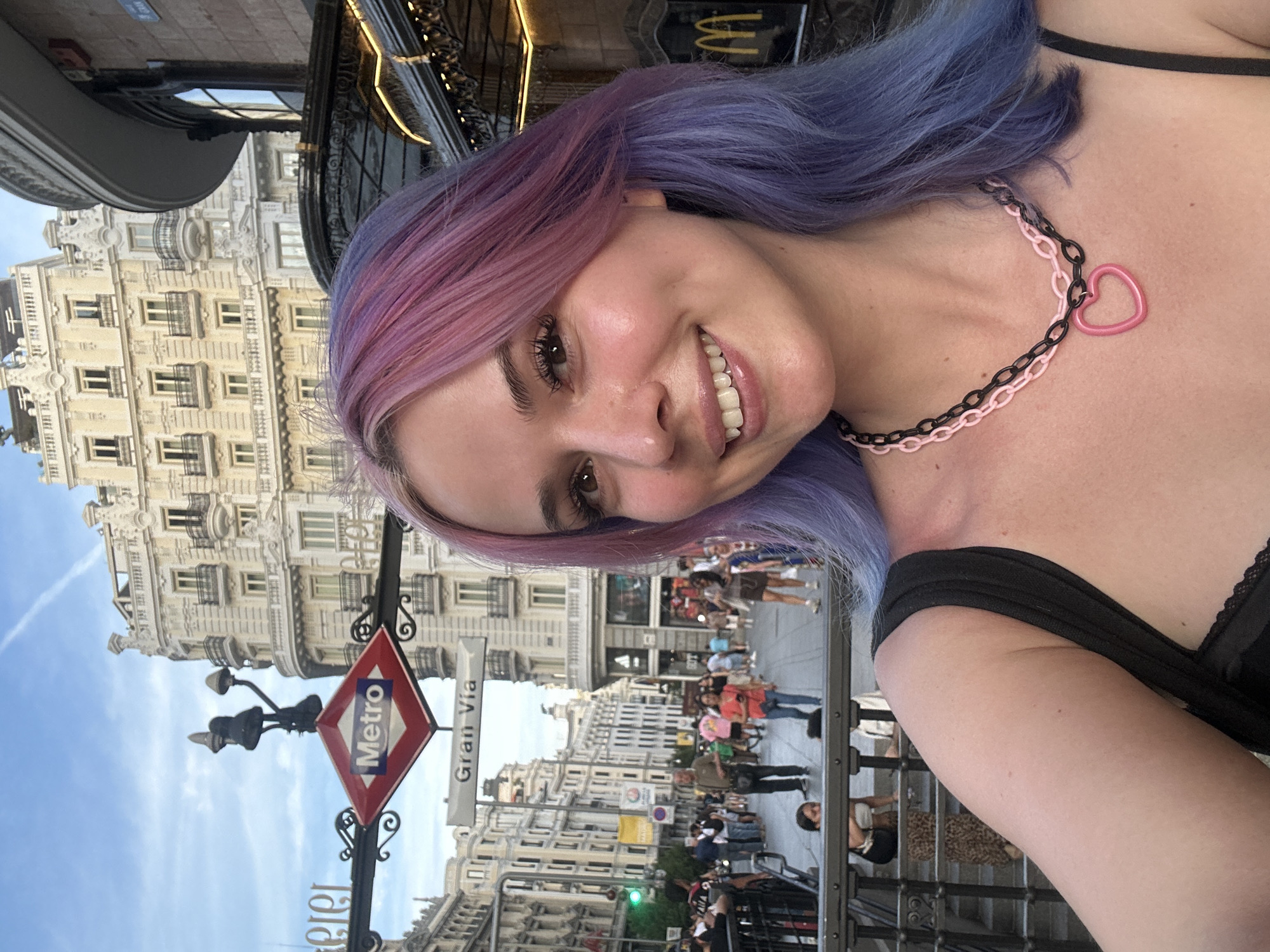Tourist documents evening stroll through Madrid's historic Gran Vía district