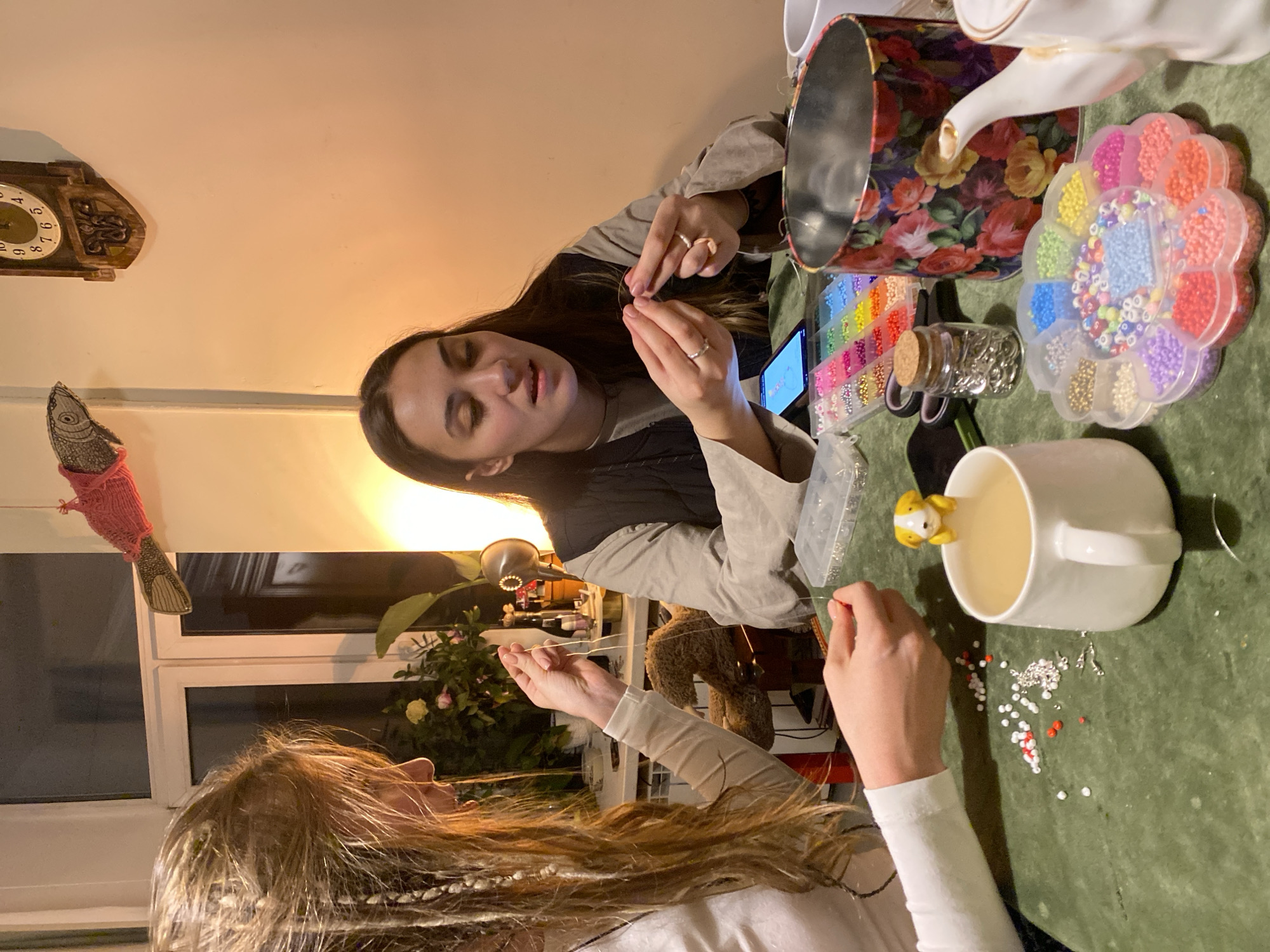 Two women craft beaded jewelry in Moscow