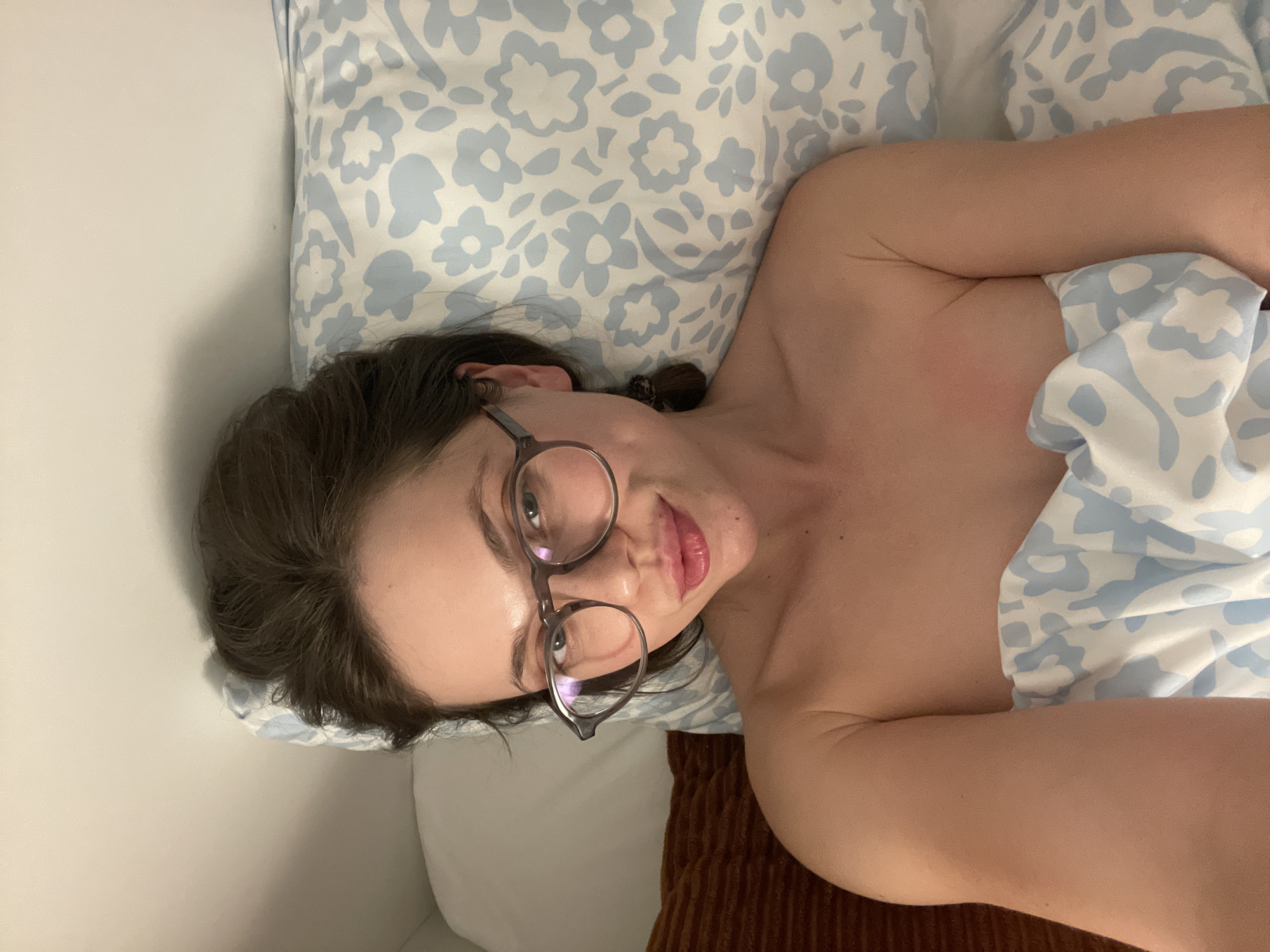 Woman rests in bed in Budapest apartment