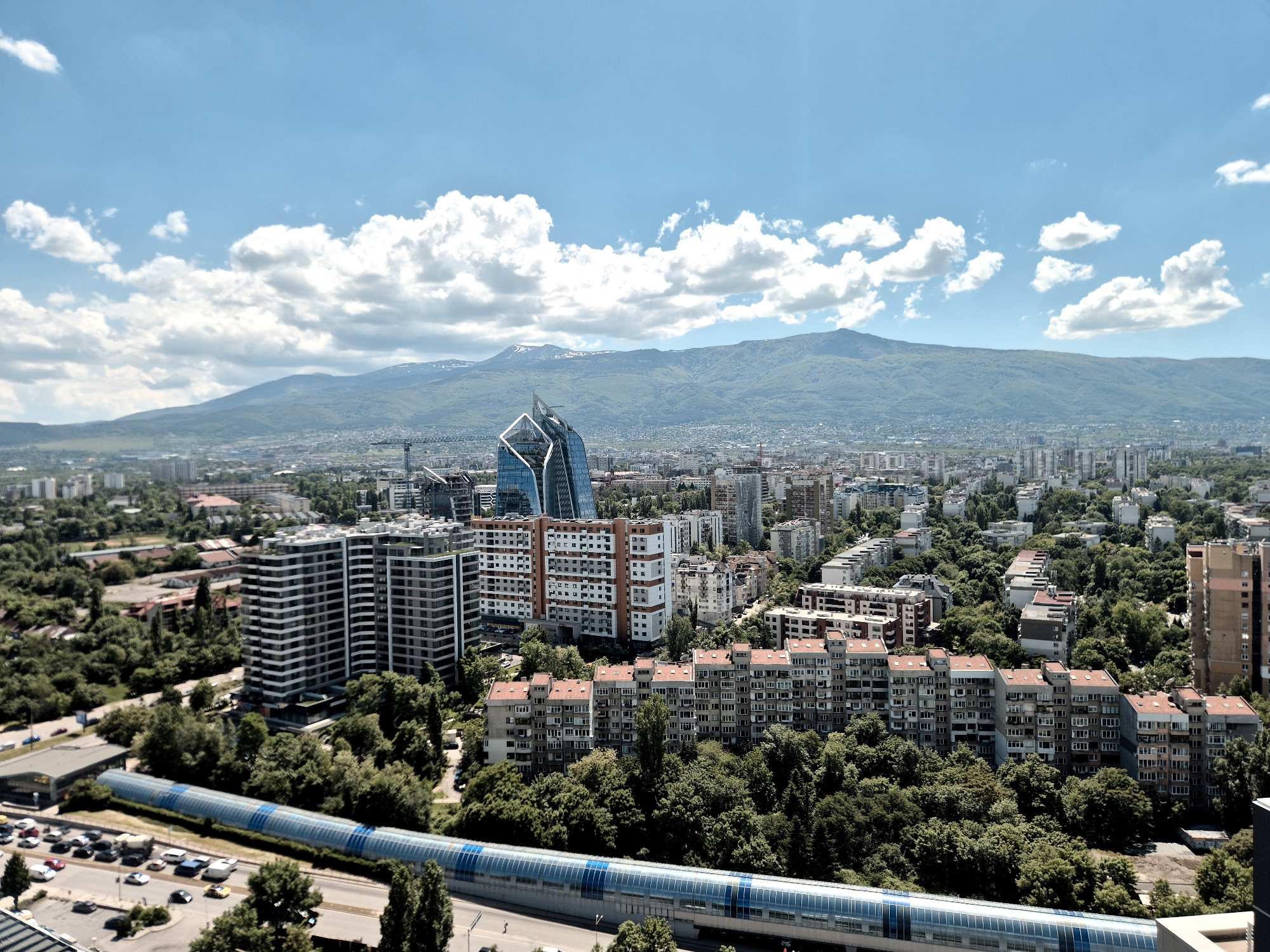 Aerial view captures Sofia cityscape with mountain backdrop