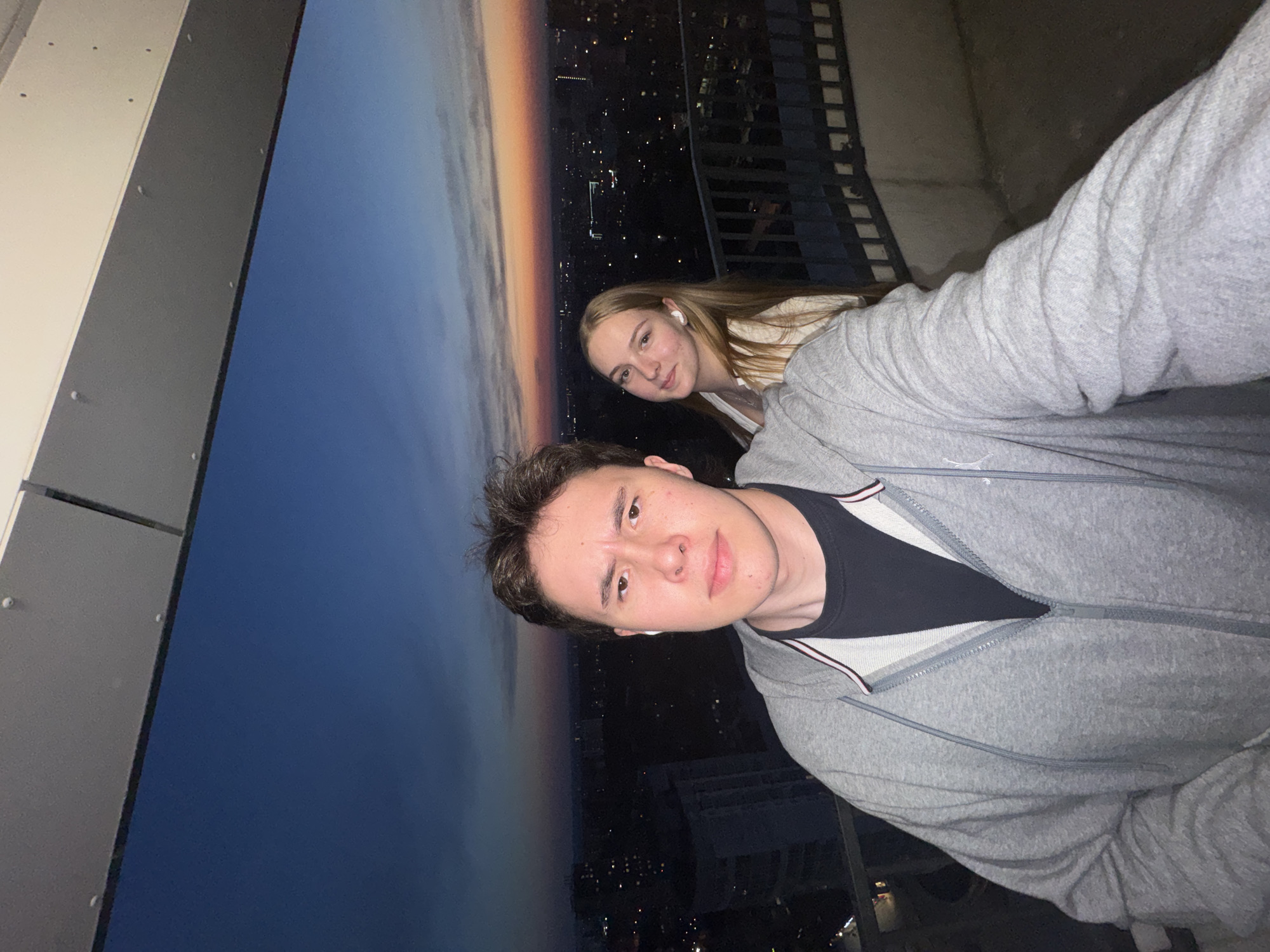 Couple photographs selfie on Perm balcony at dusk