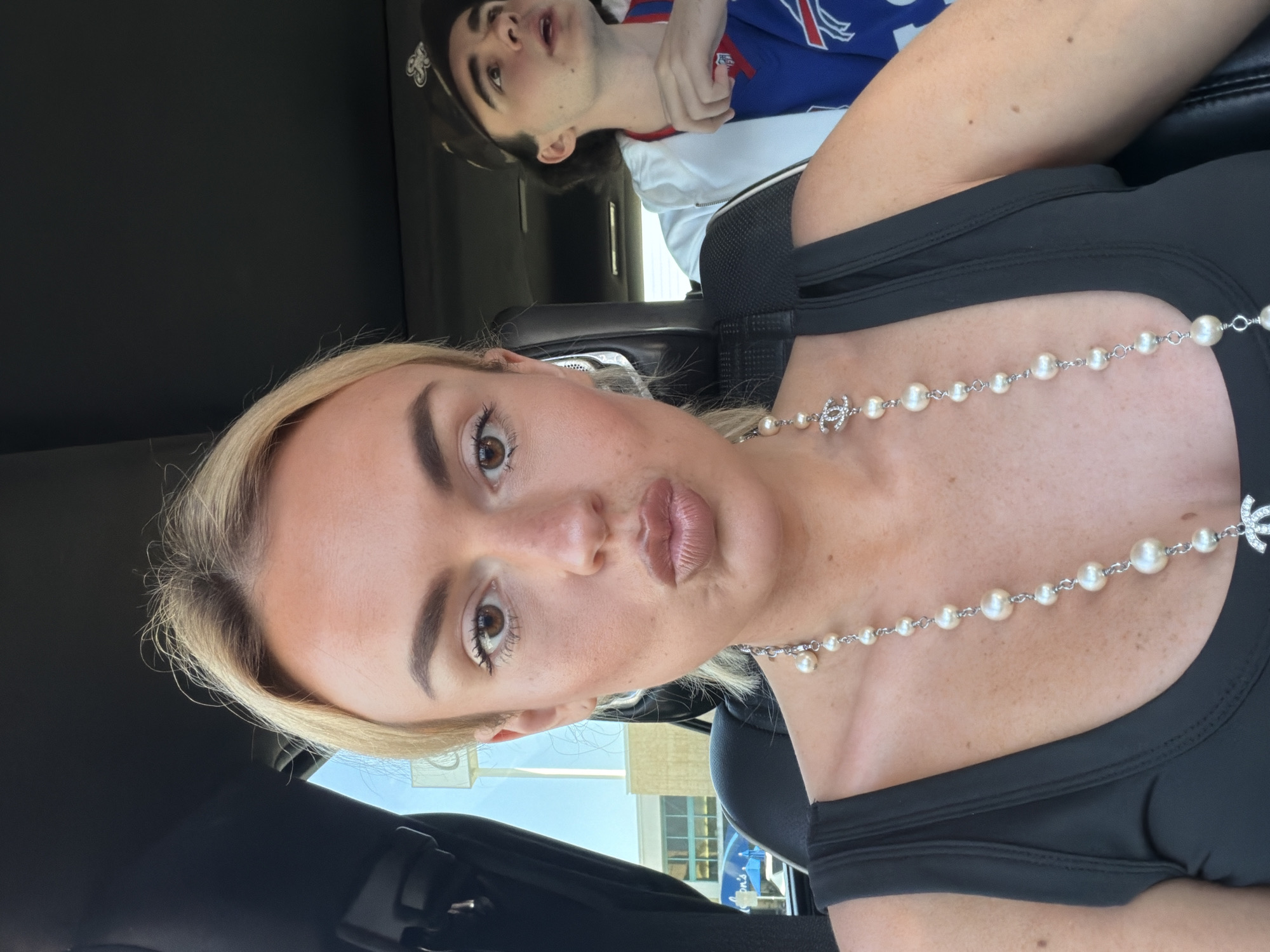 Woman takes selfie in car during evening in Los Angeles